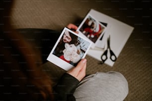 a person holding a polaroid with a picture of a dog