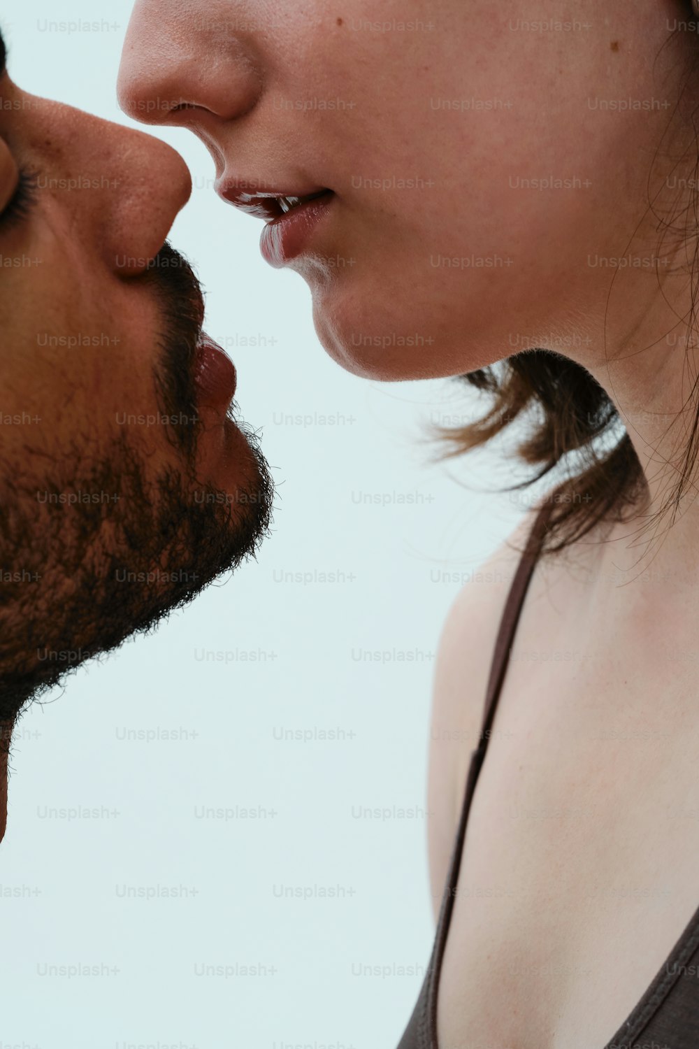 a close up of a person kissing another person