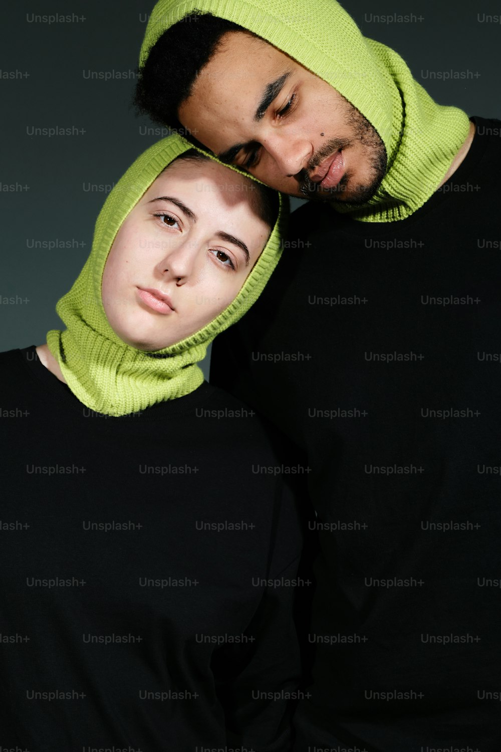 a man and a woman wearing a green hat