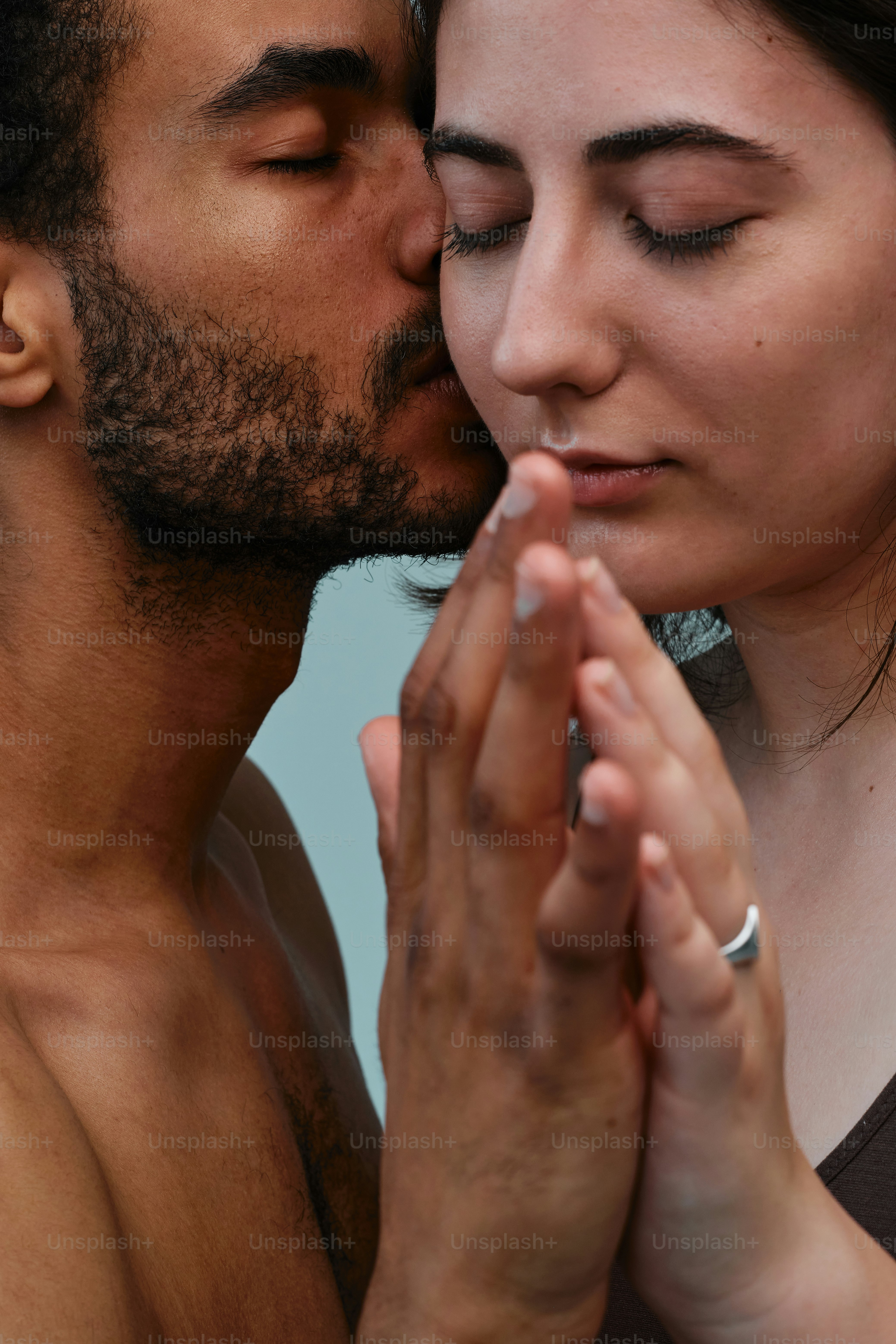 Studio portrait of a multinational couple in a moment of tenderness