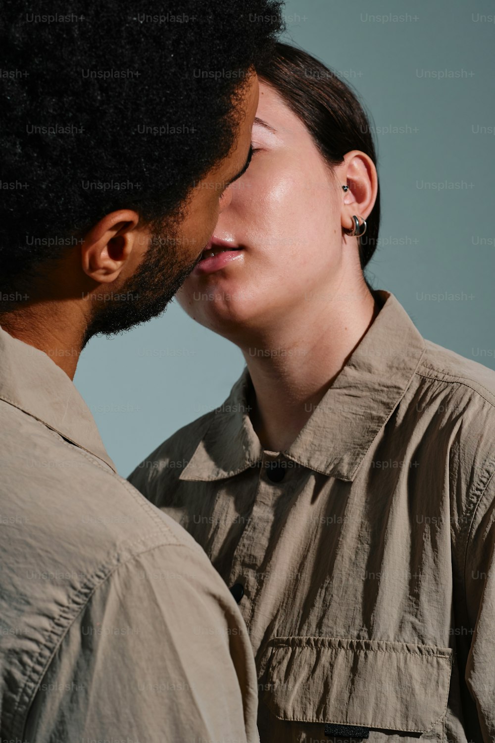 a man and a woman kissing each other
