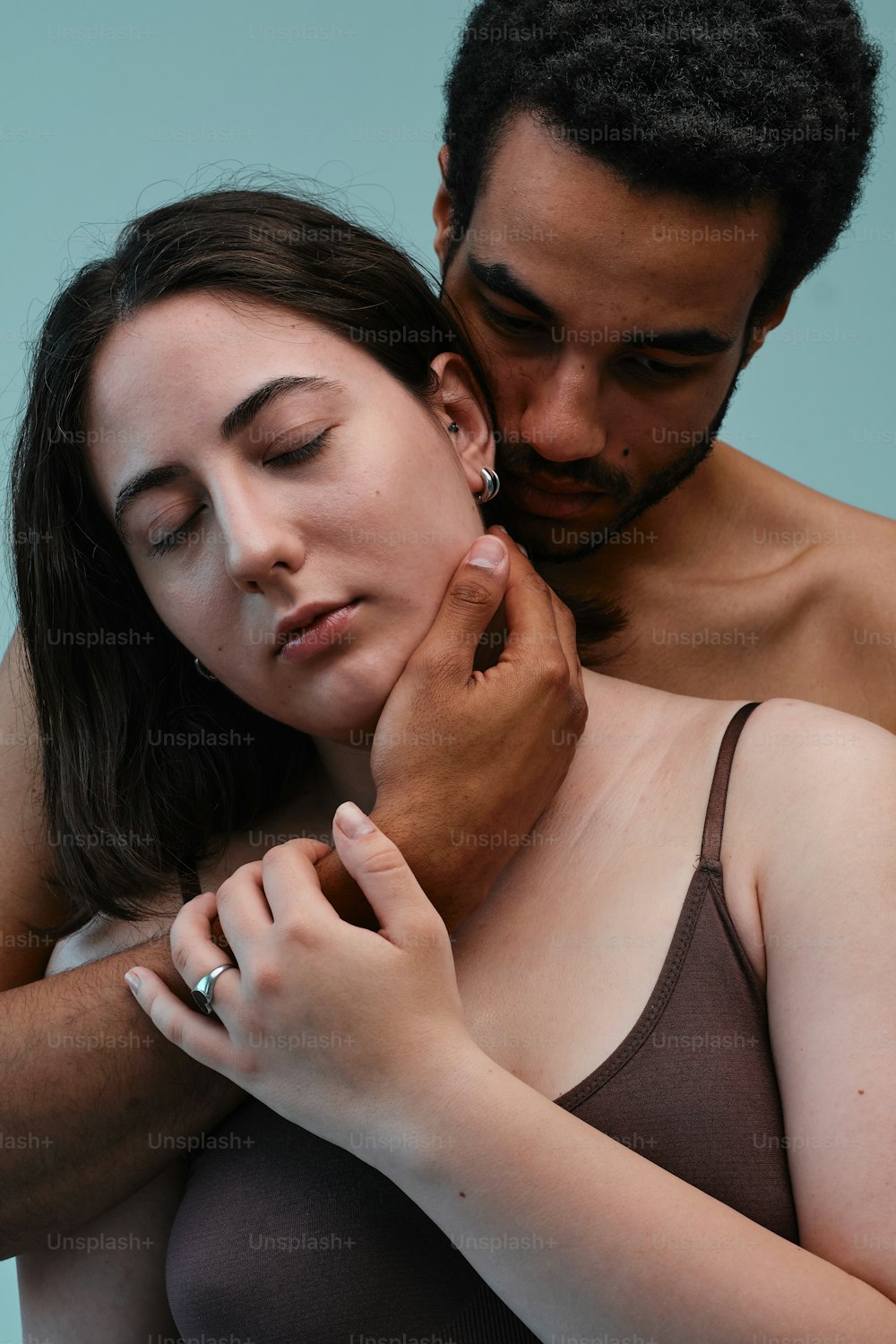 a woman in a bra touching the chest of a man
