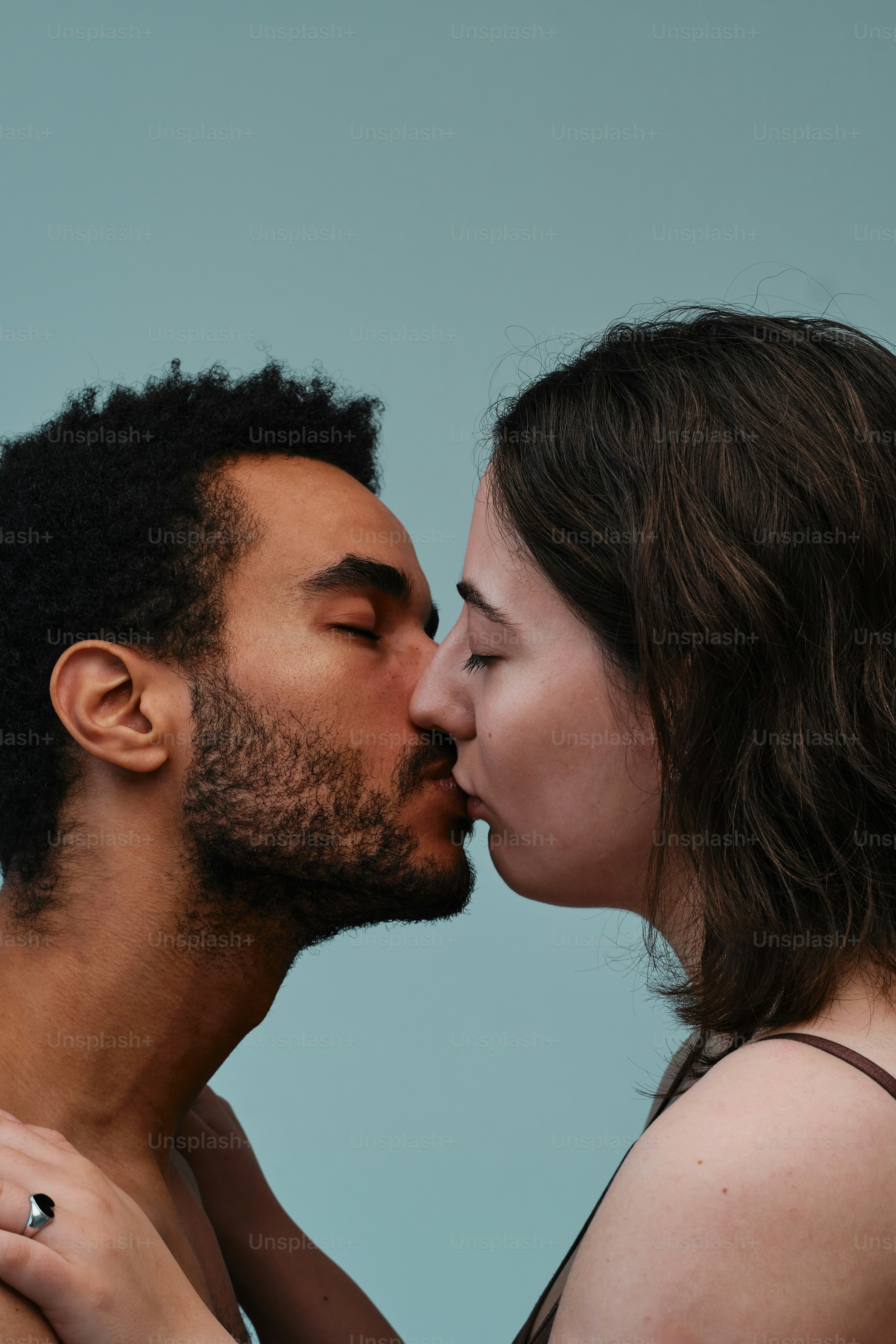 Studio portrait of a multinational couple in a moment of tenderness