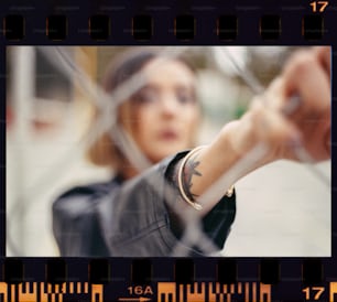 a woman with a wrist tattoo holding a camera