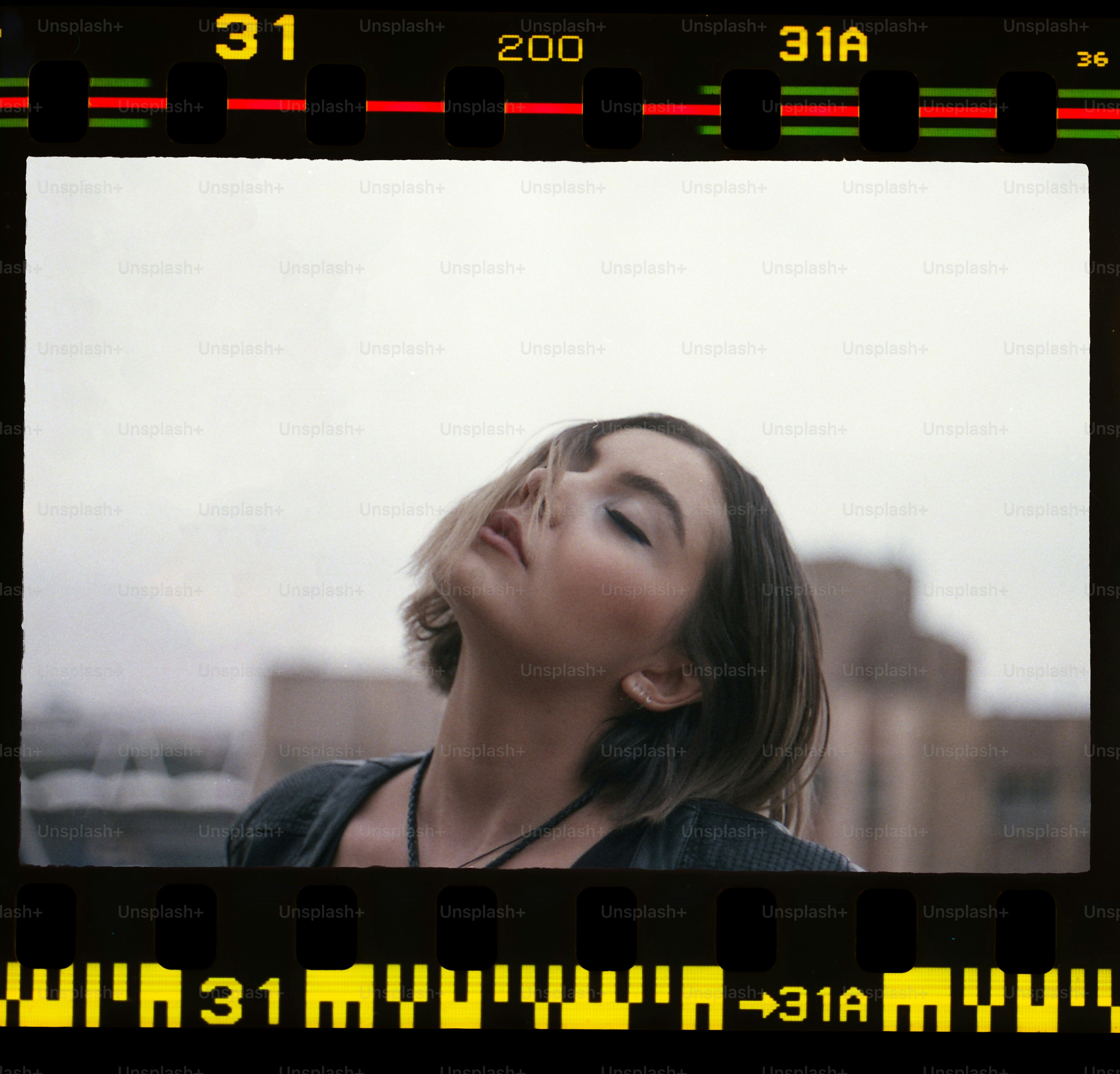 a woman with her eyes closed looking up