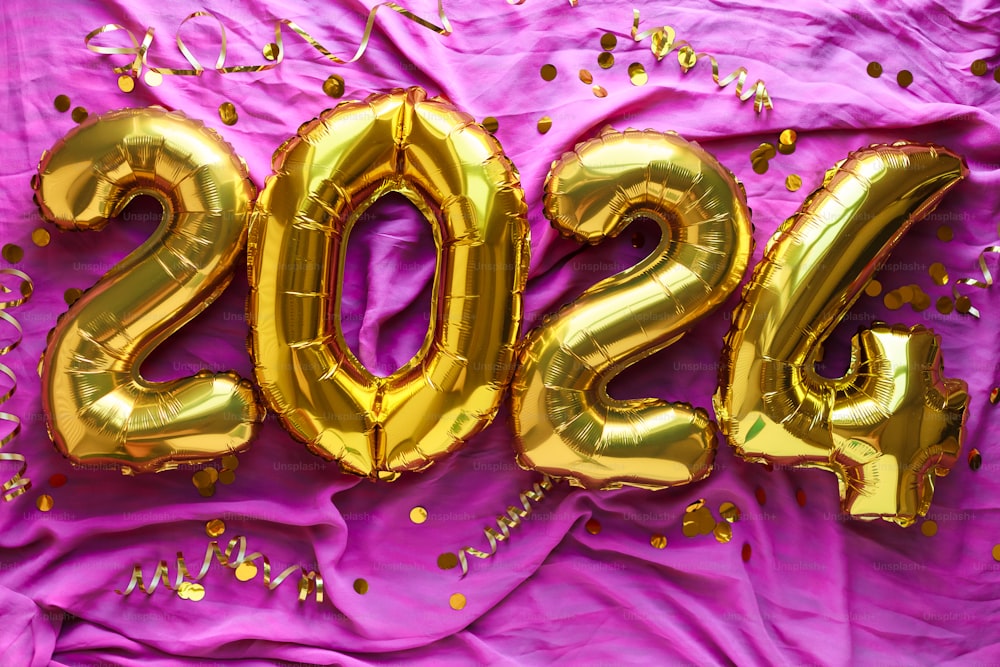 a purple sheet with gold foil numbers and confetti