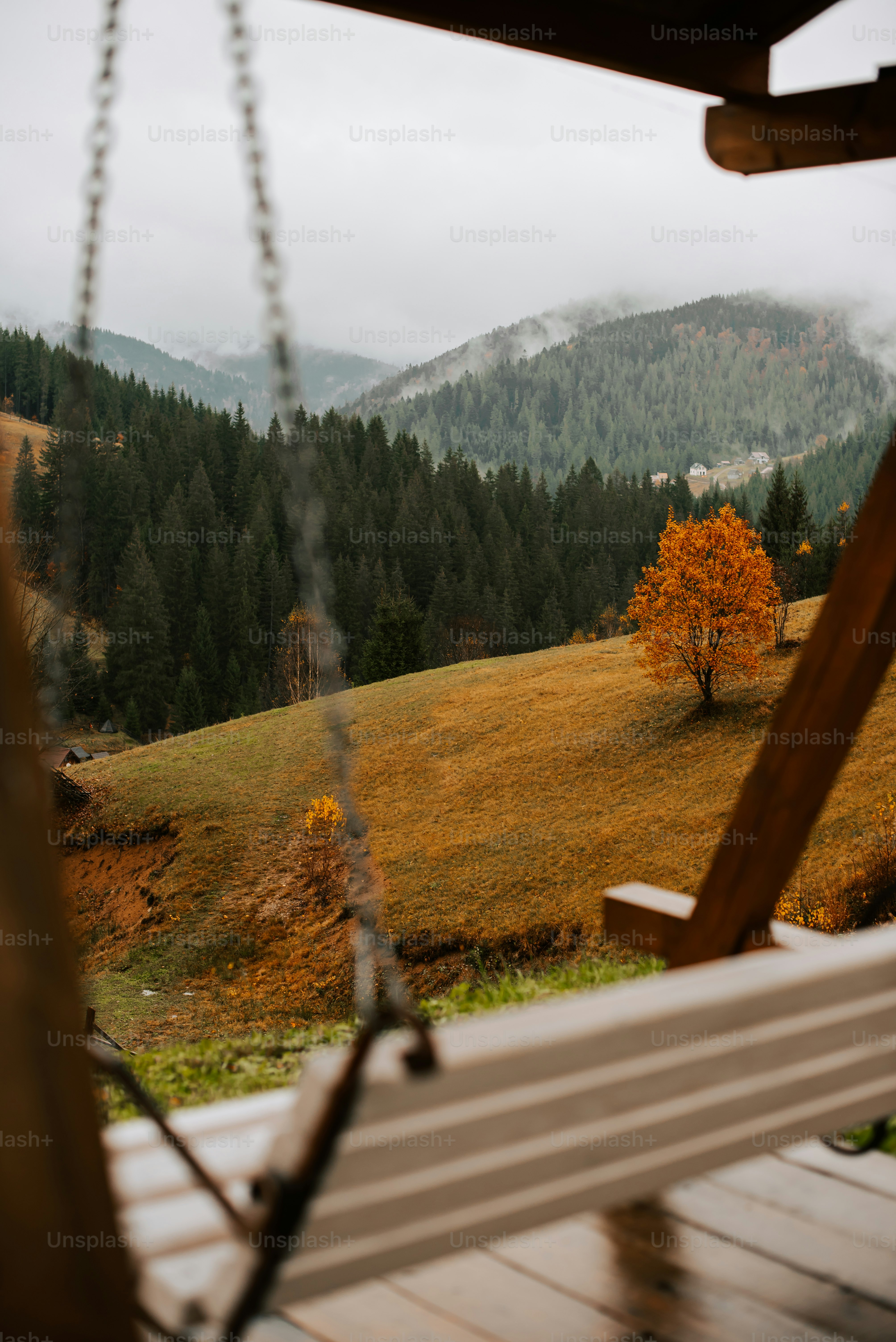 a wooden swing sitting on top of a wooden deck