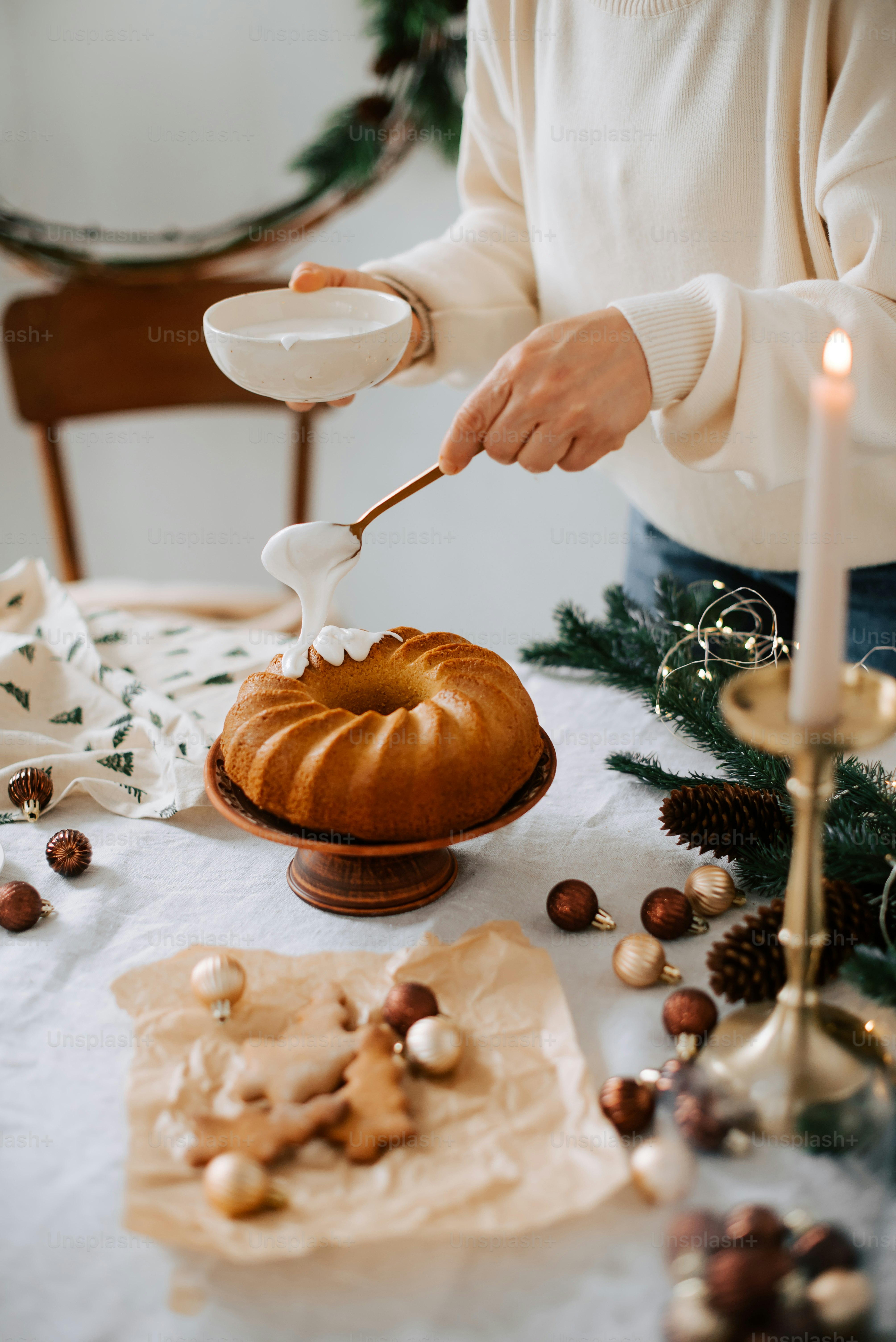 a person is spreading icing on a bundt cake