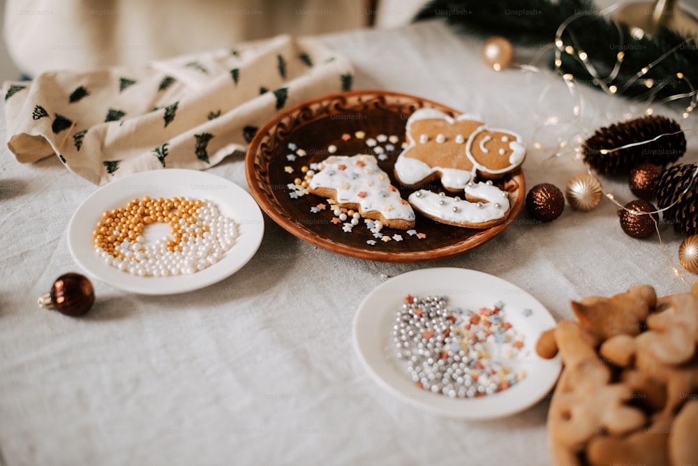 a table topped with white plates filled with cookies