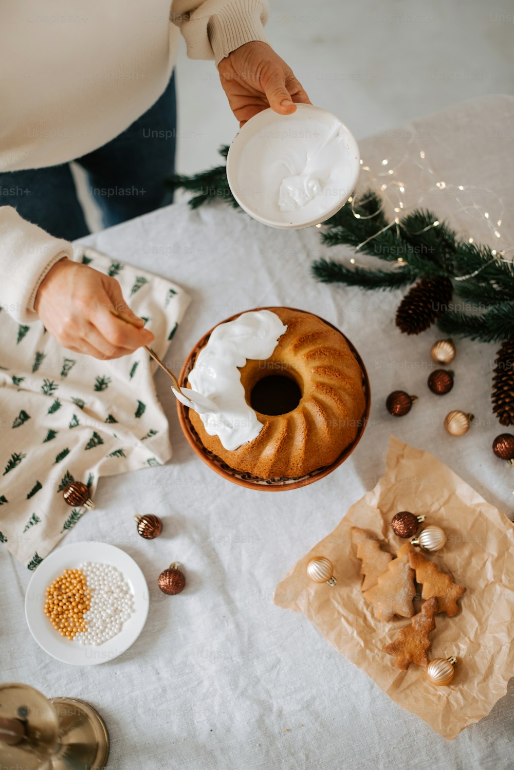 a person is putting icing on a bundt cake