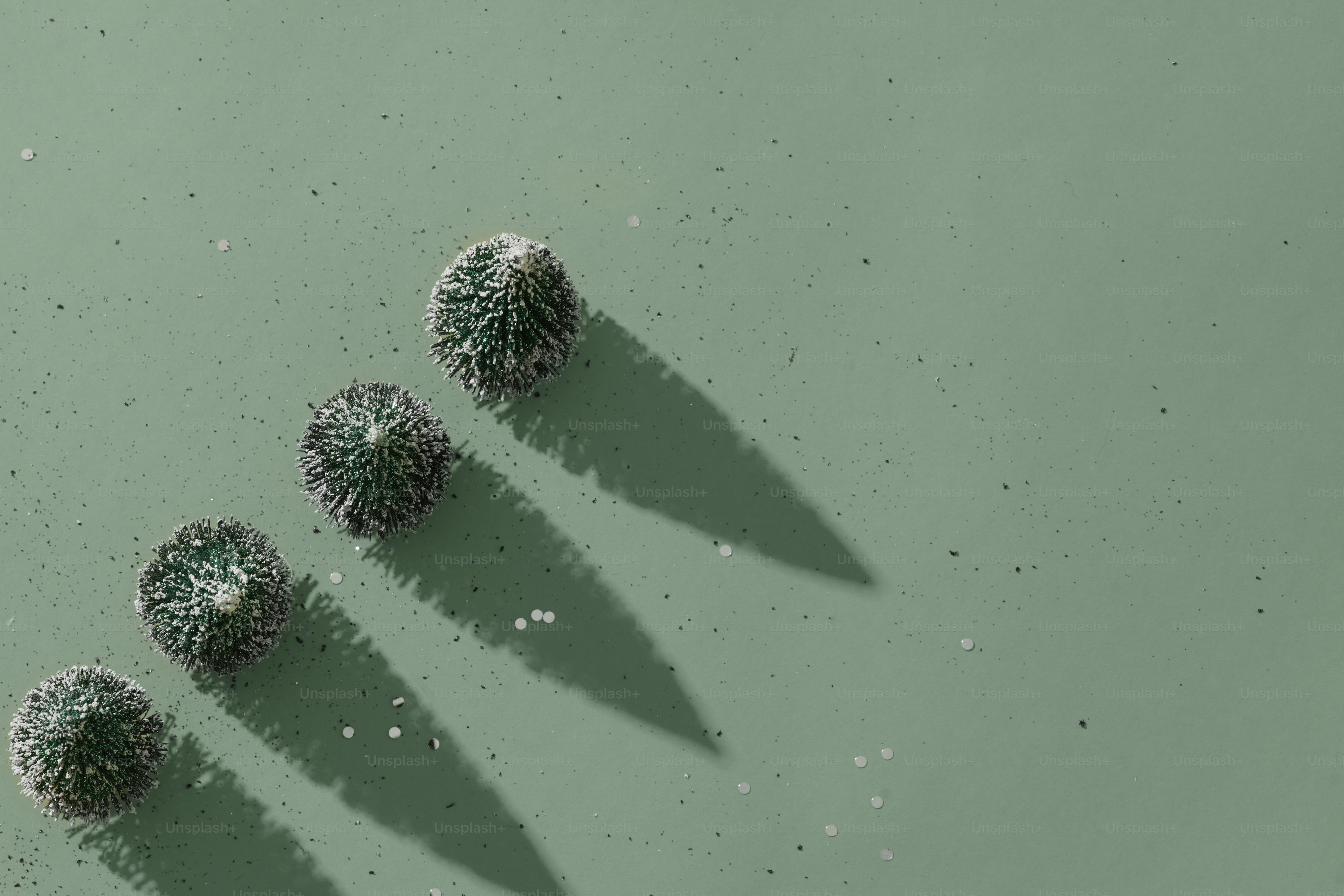 a group of three green balls sitting on top of a green surface