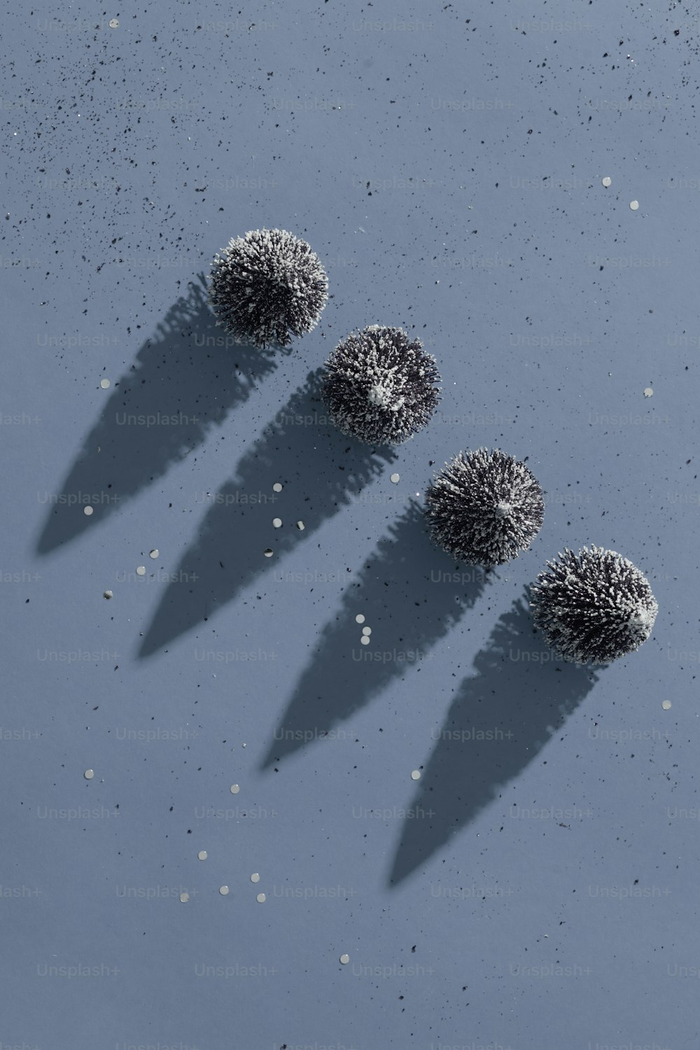 a group of three balls sitting on top of a blue surface
