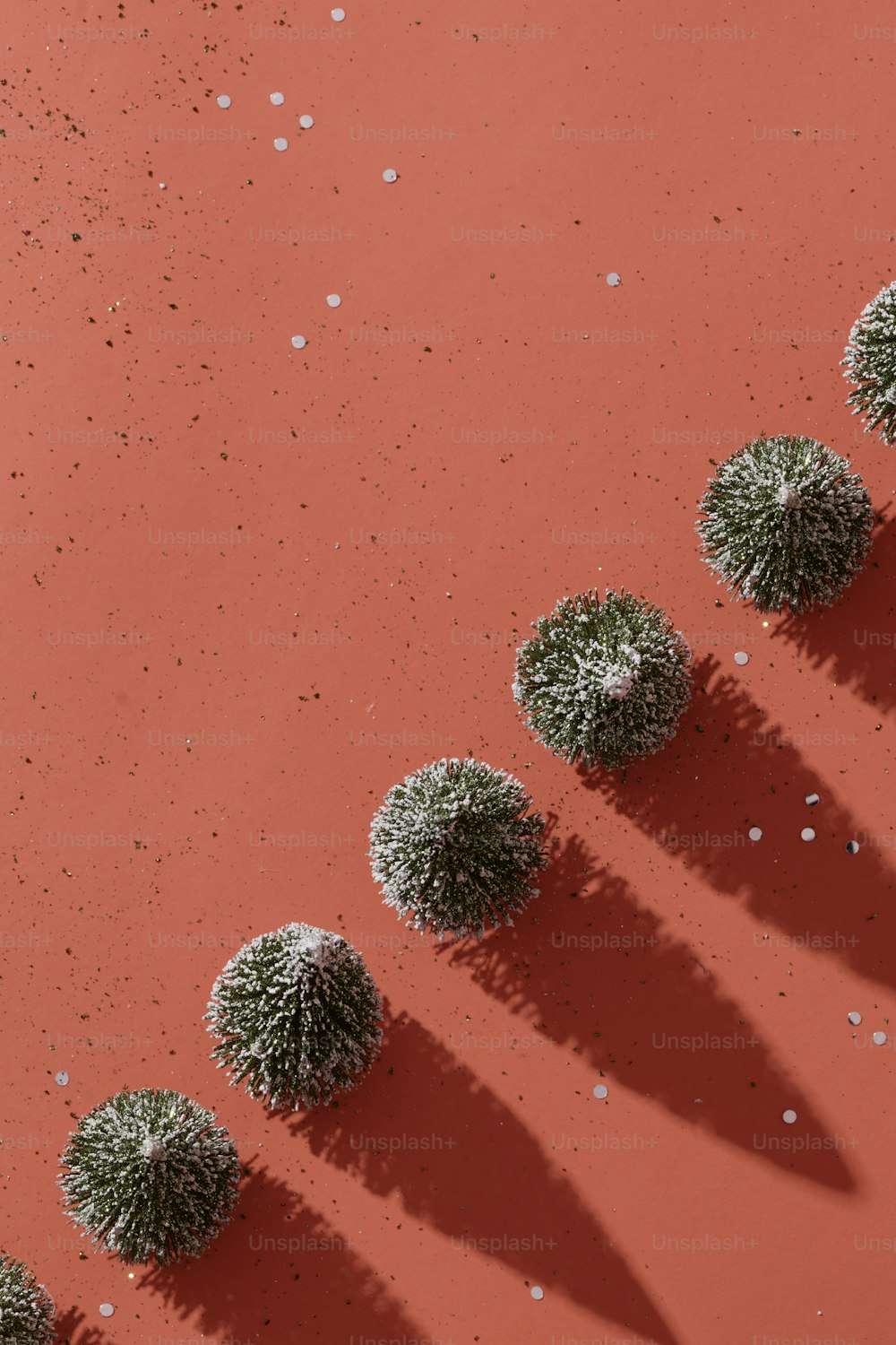 a group of small green plants sitting on top of a red surface