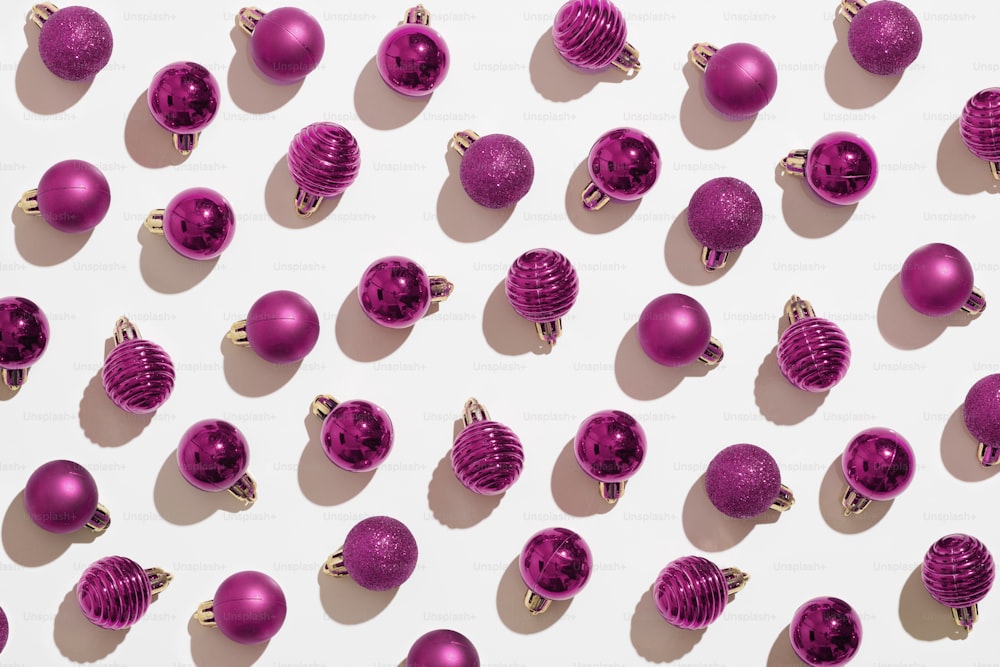 a group of pink ornaments sitting on top of a white surface