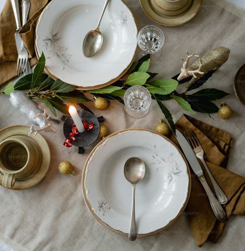 a table set for christmas with silverware and decorations
