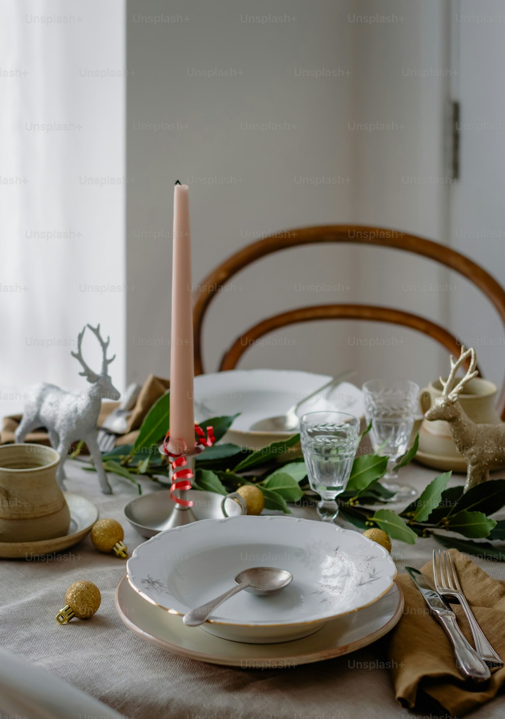 a table set for christmas with a lit candle