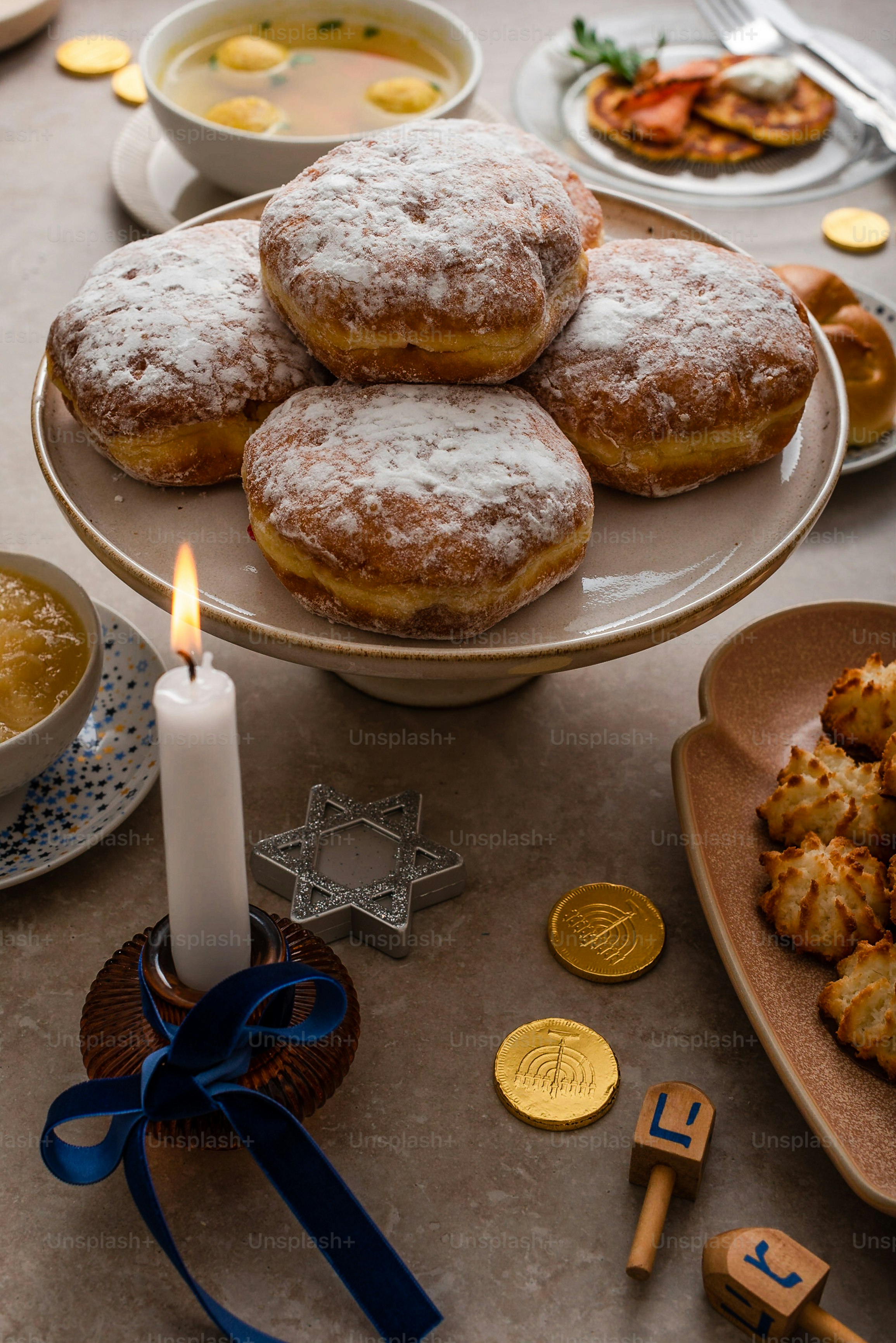 a table topped with plates of food and a candle