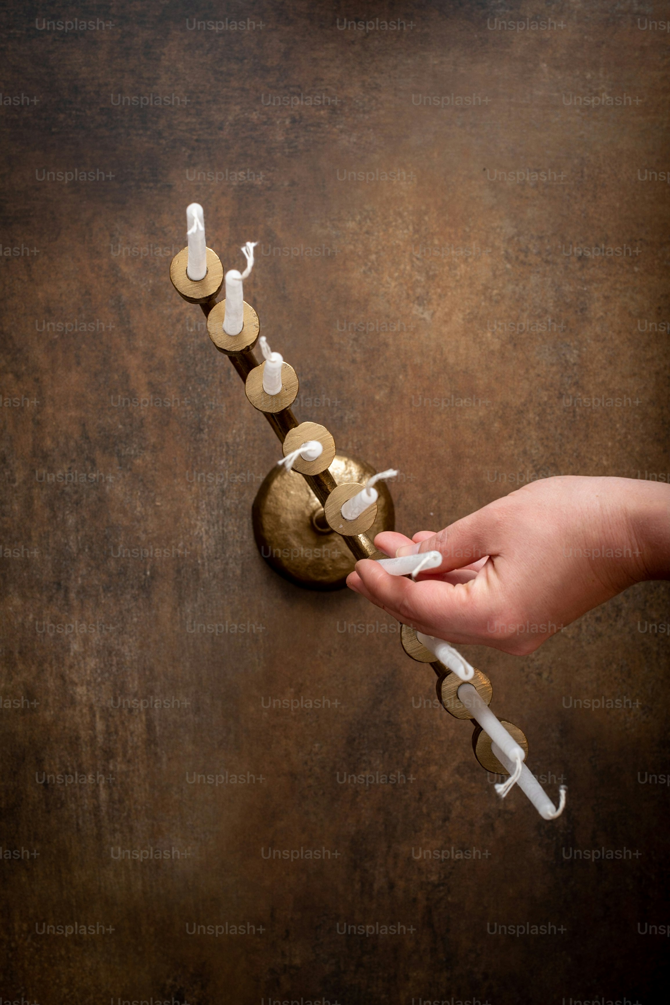 a person holding a toothbrush in front of a toothbrush holder