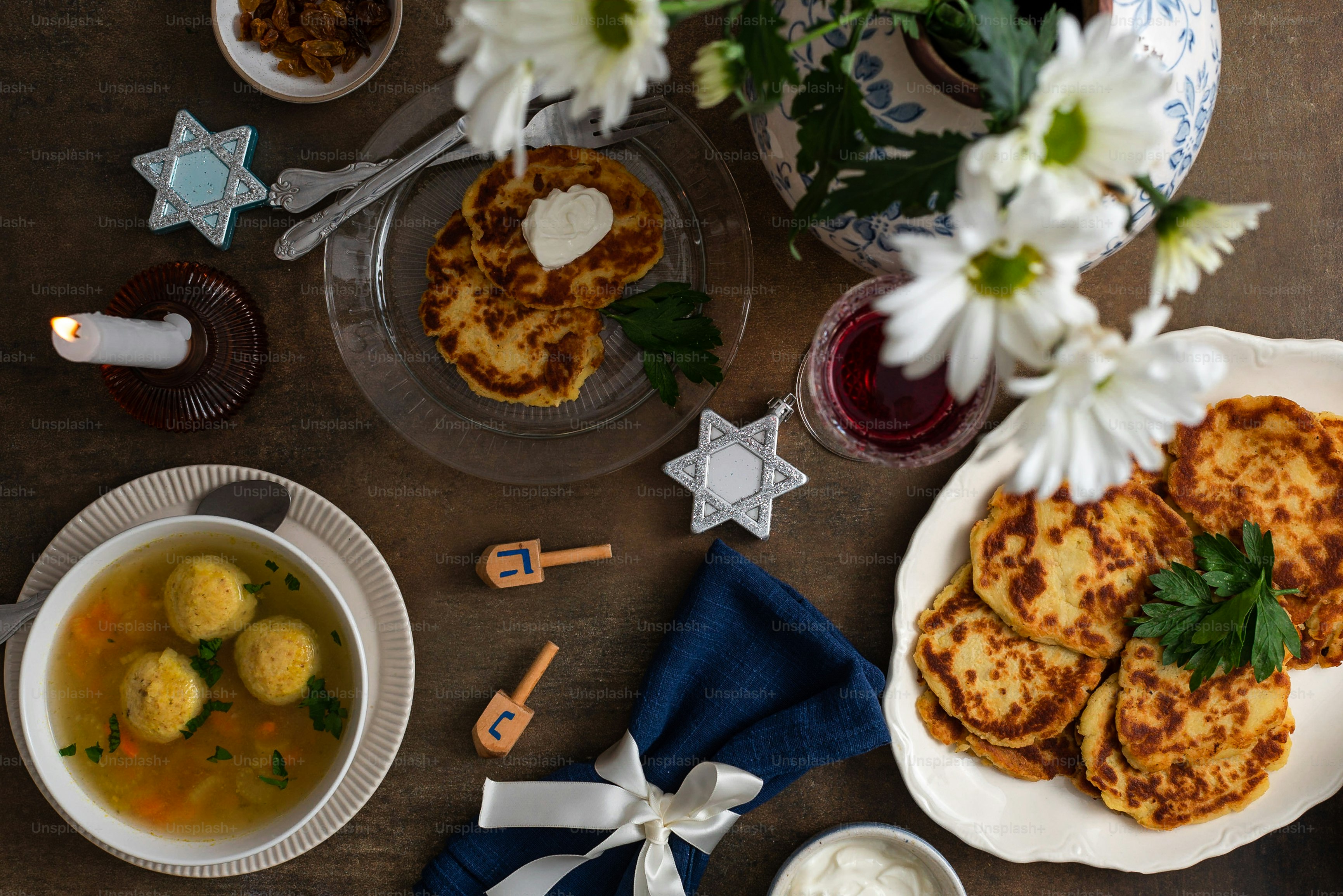 a table topped with plates of food and a bowl of soup
