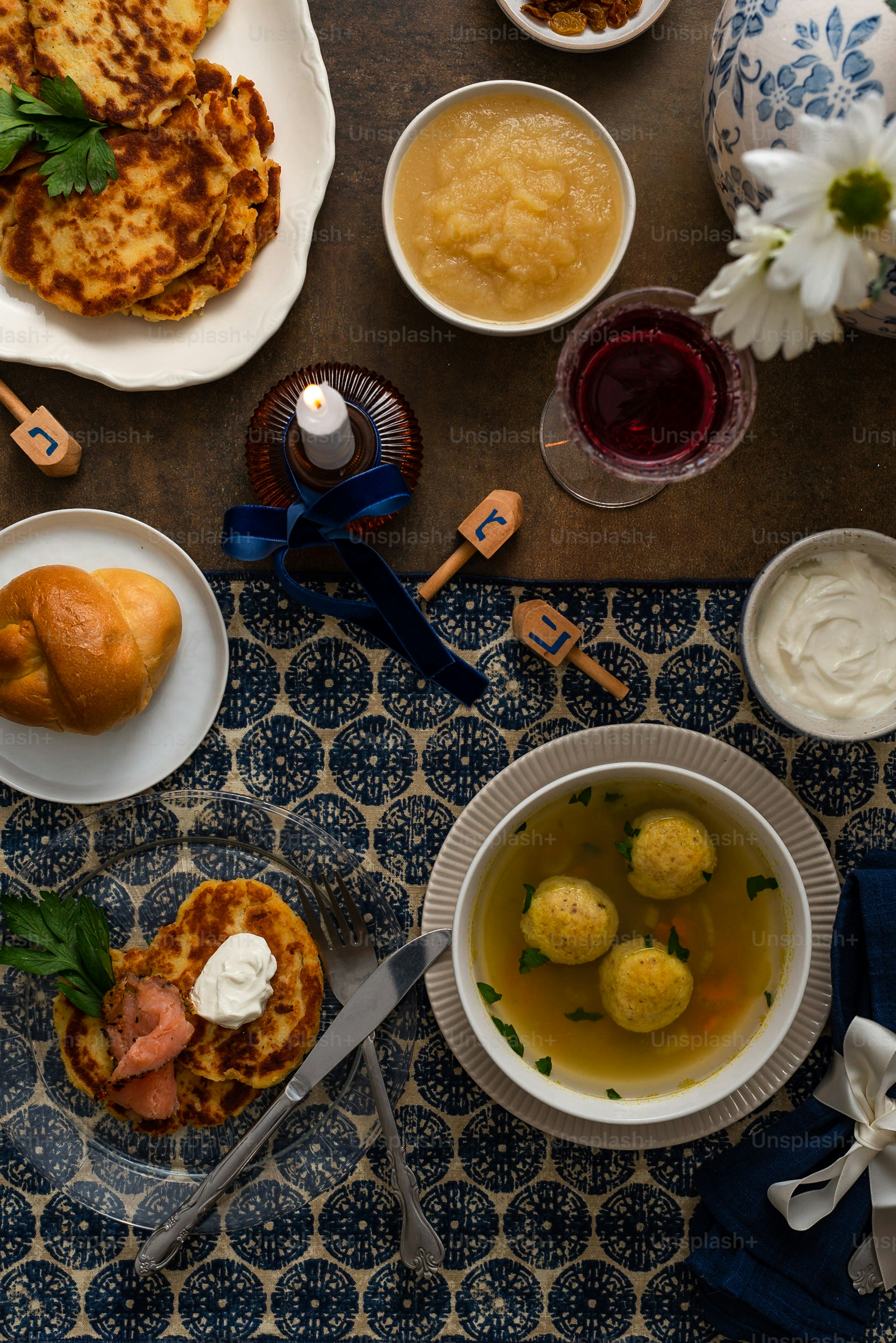 a table topped with plates of food and bowls of soup