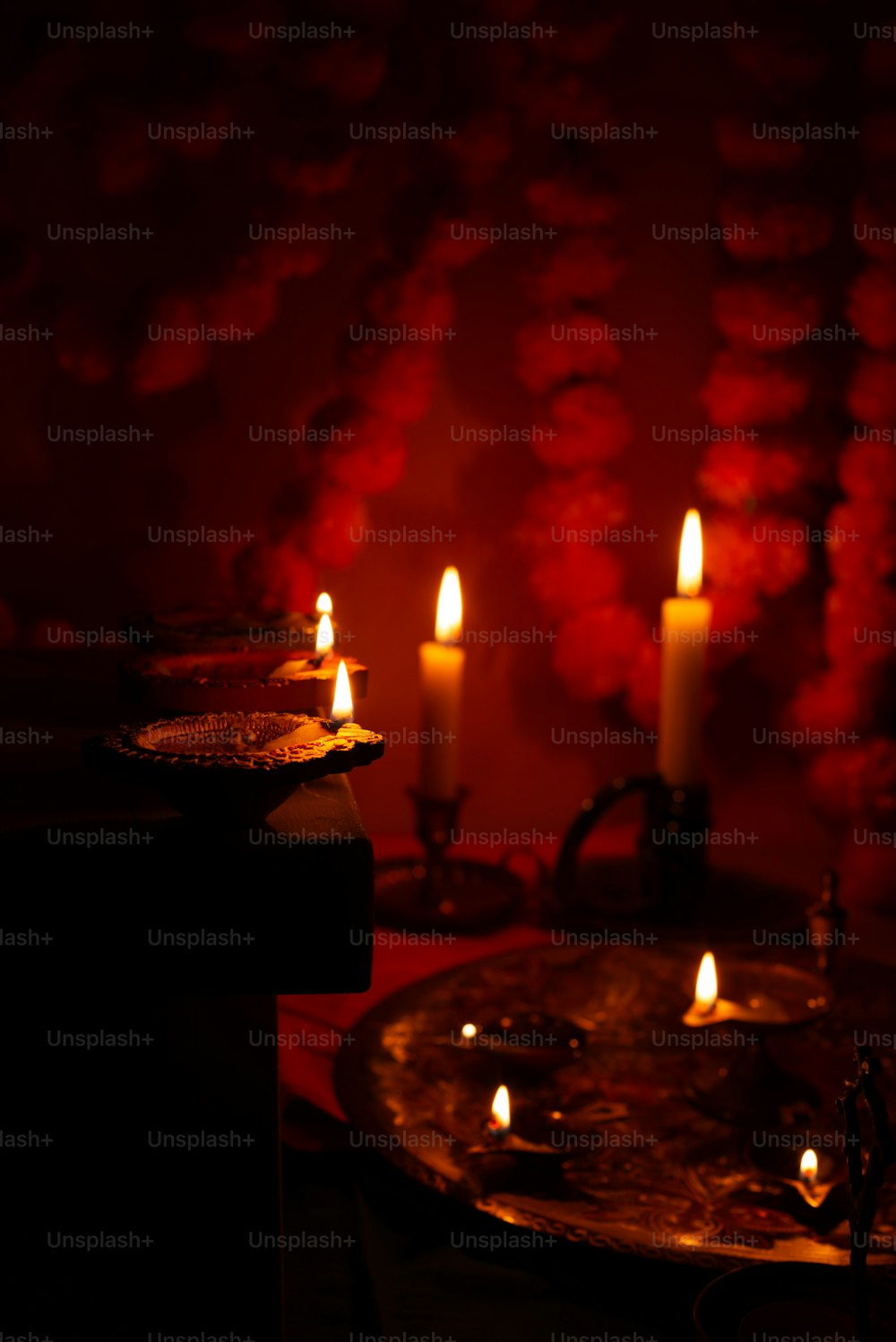 three lit candles sitting on top of a table