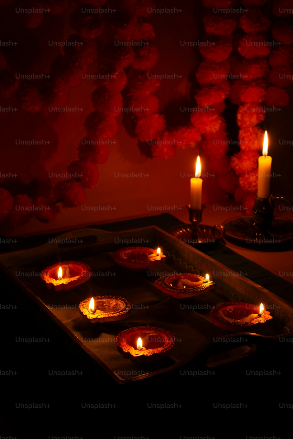 a tray with some lit candles on it