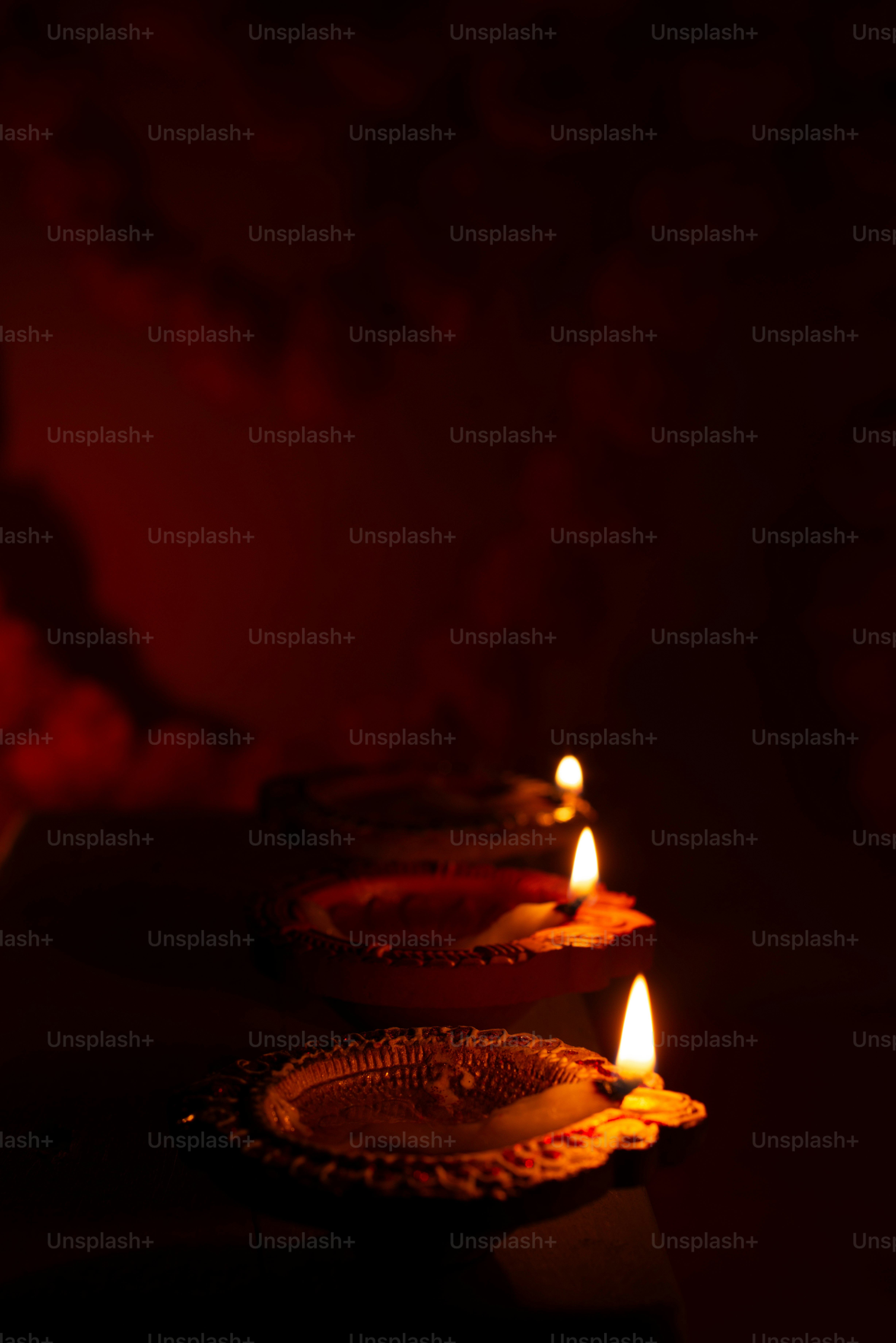 a row of lit candles sitting on top of a table