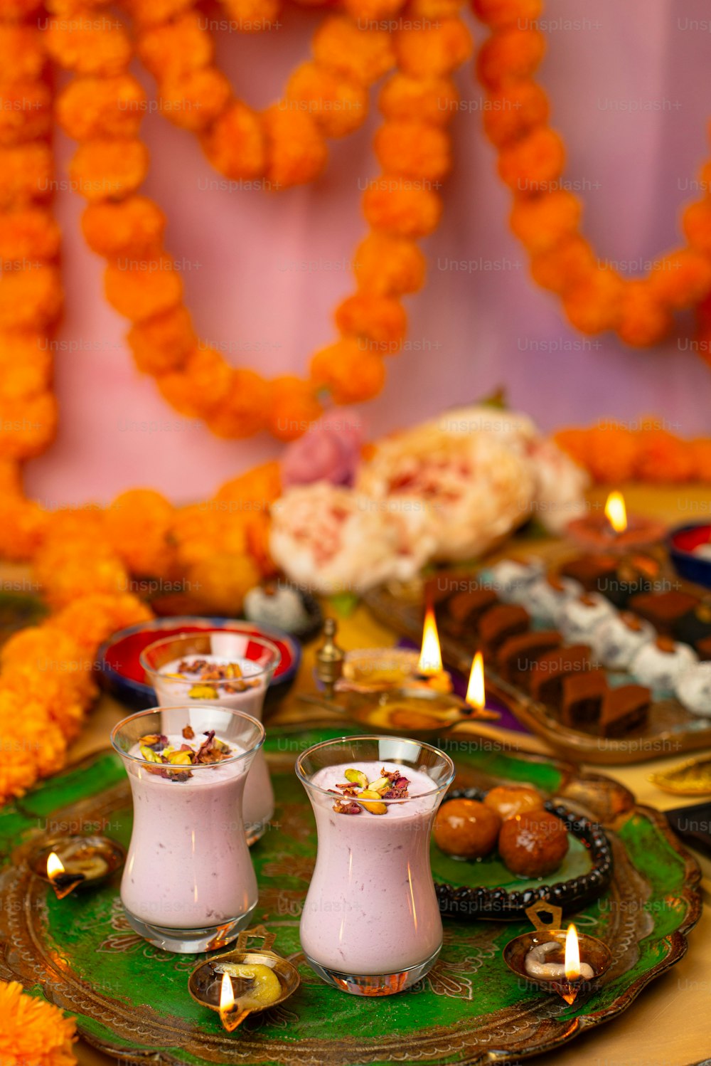 a table topped with plates of food and candles