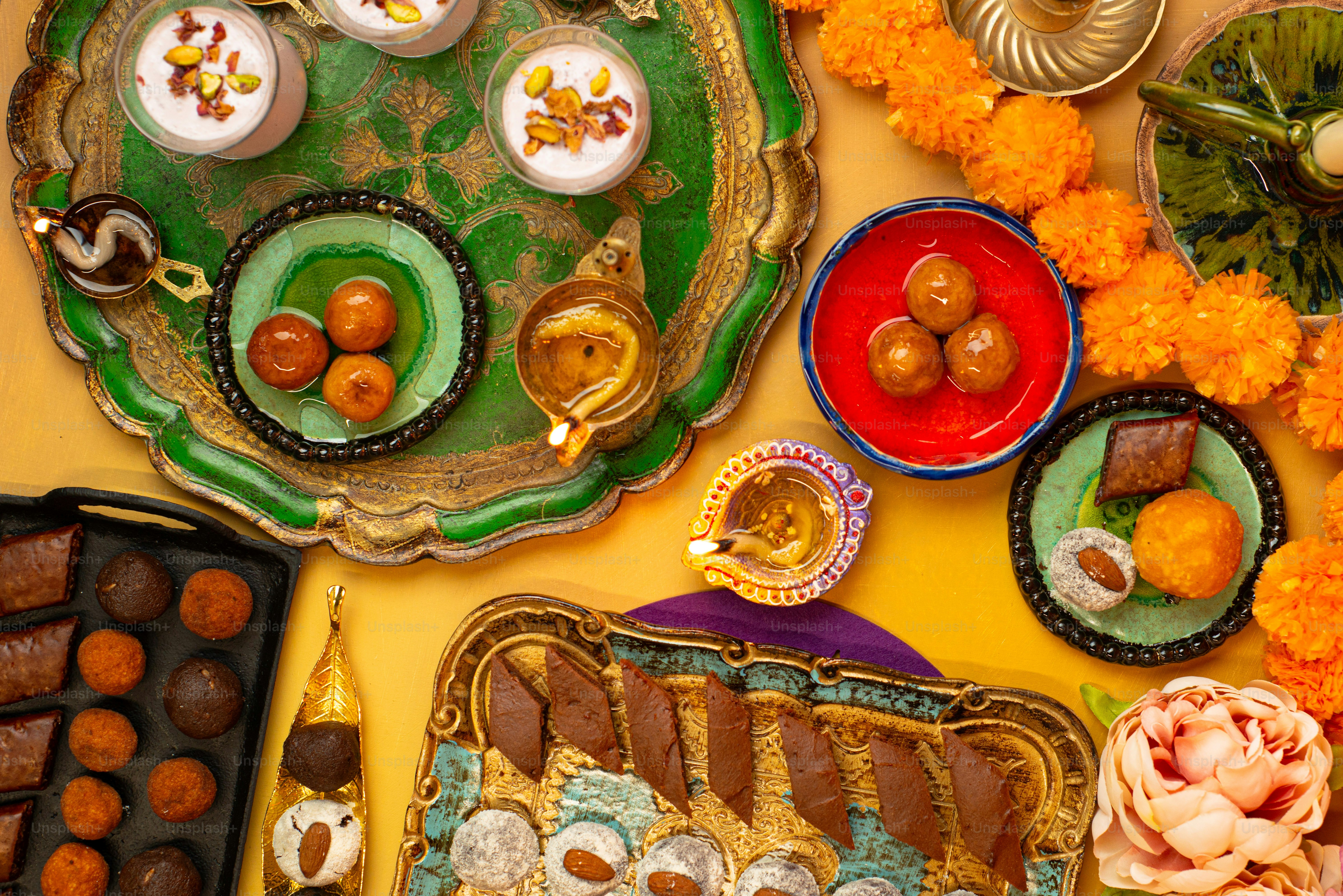 a table topped with plates and trays of food