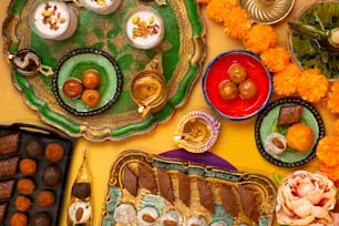 a table topped with plates and trays of food