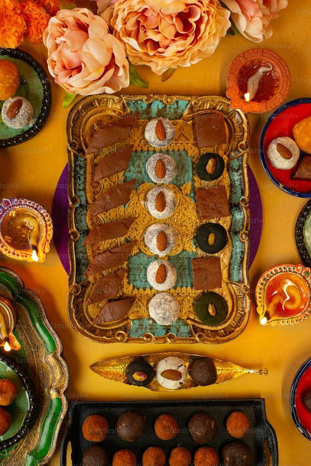 a table topped with a tray filled with donuts