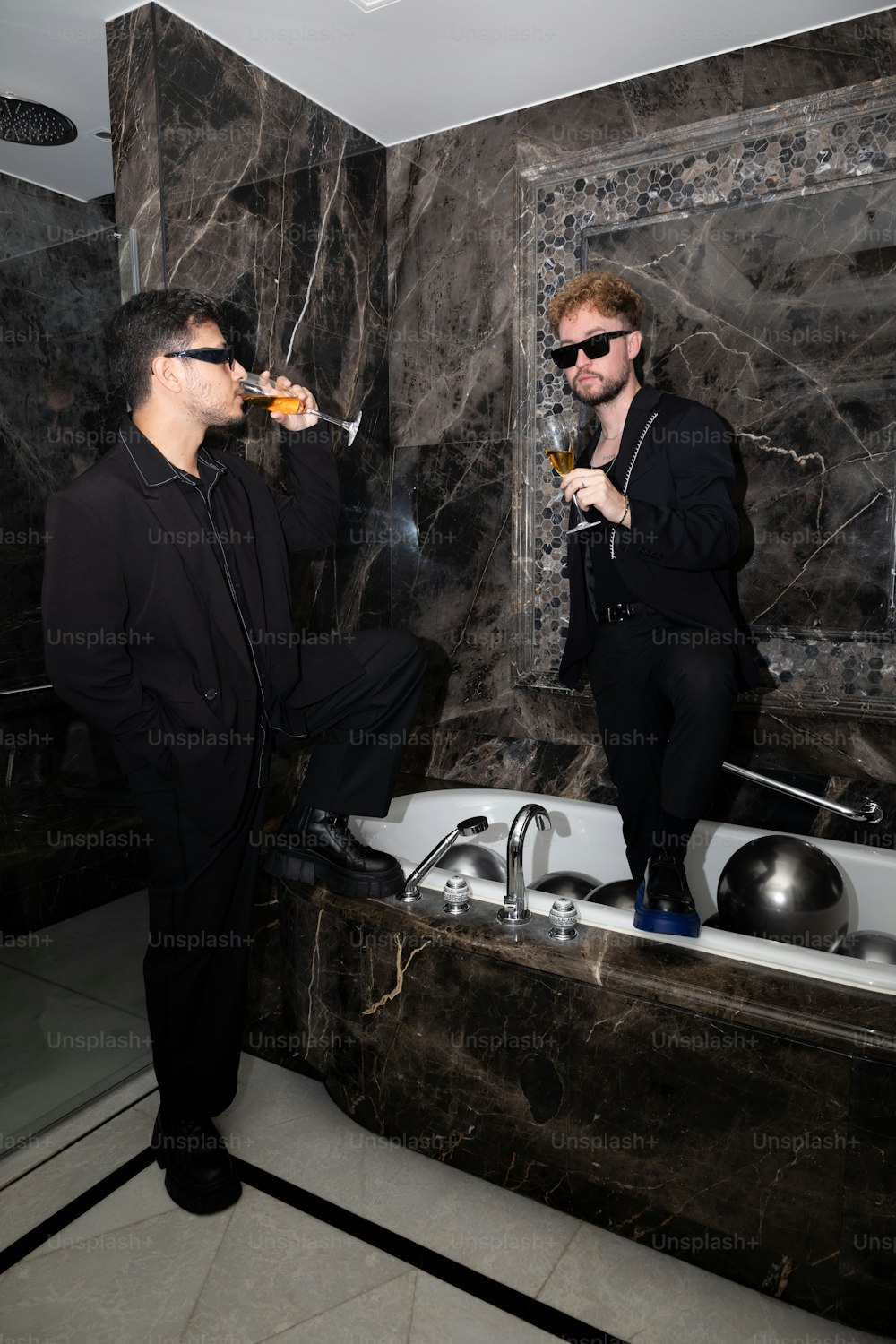 a man in a bathtub drinking a beverage