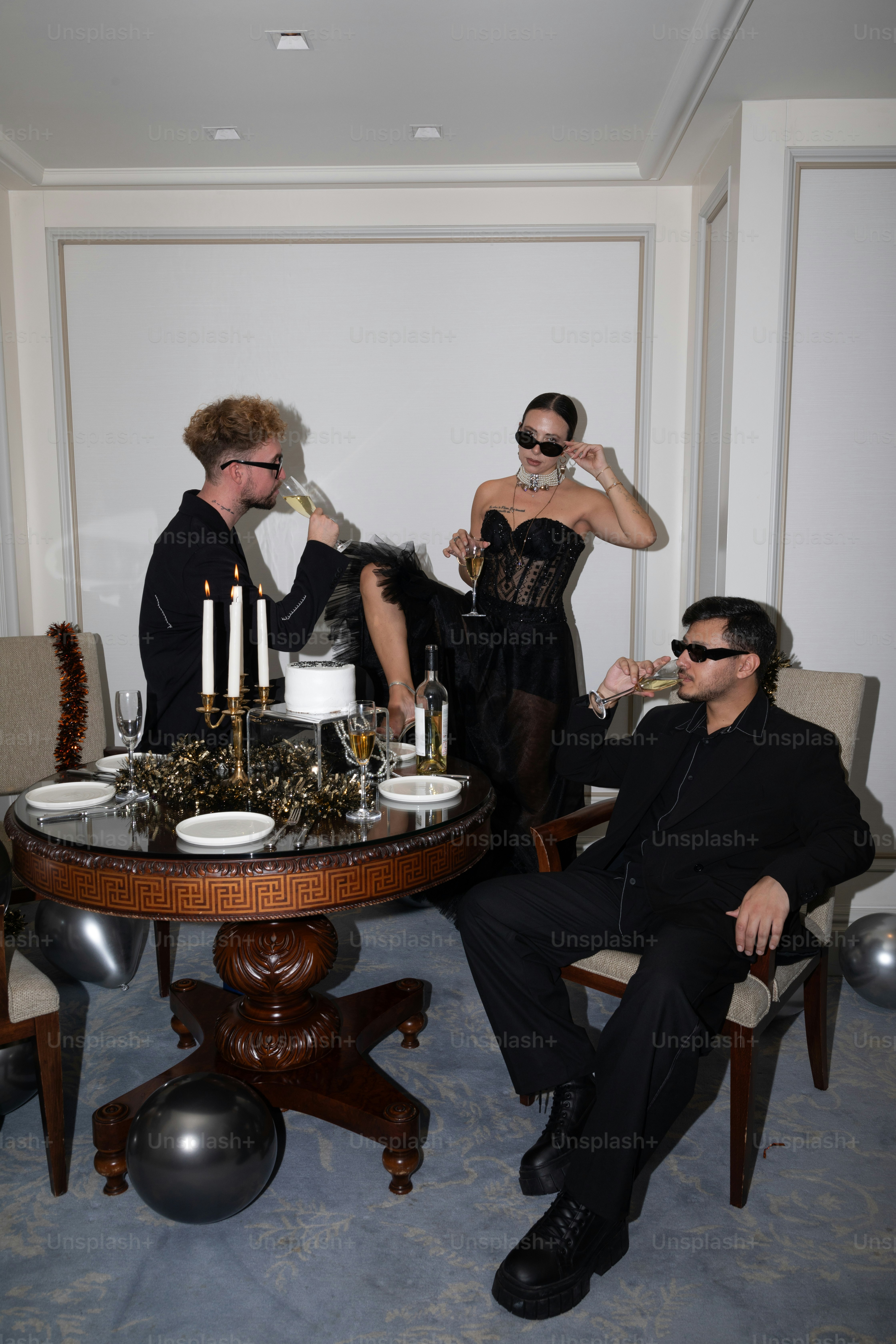 A group of people standing around a table holding wine glasses photo ...
