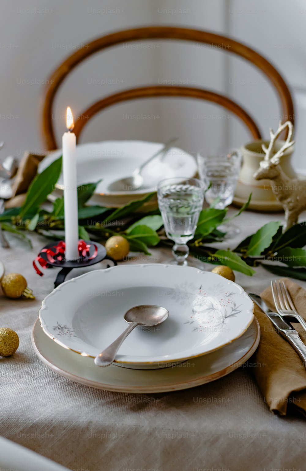 a table set for a holiday dinner with a lit candle