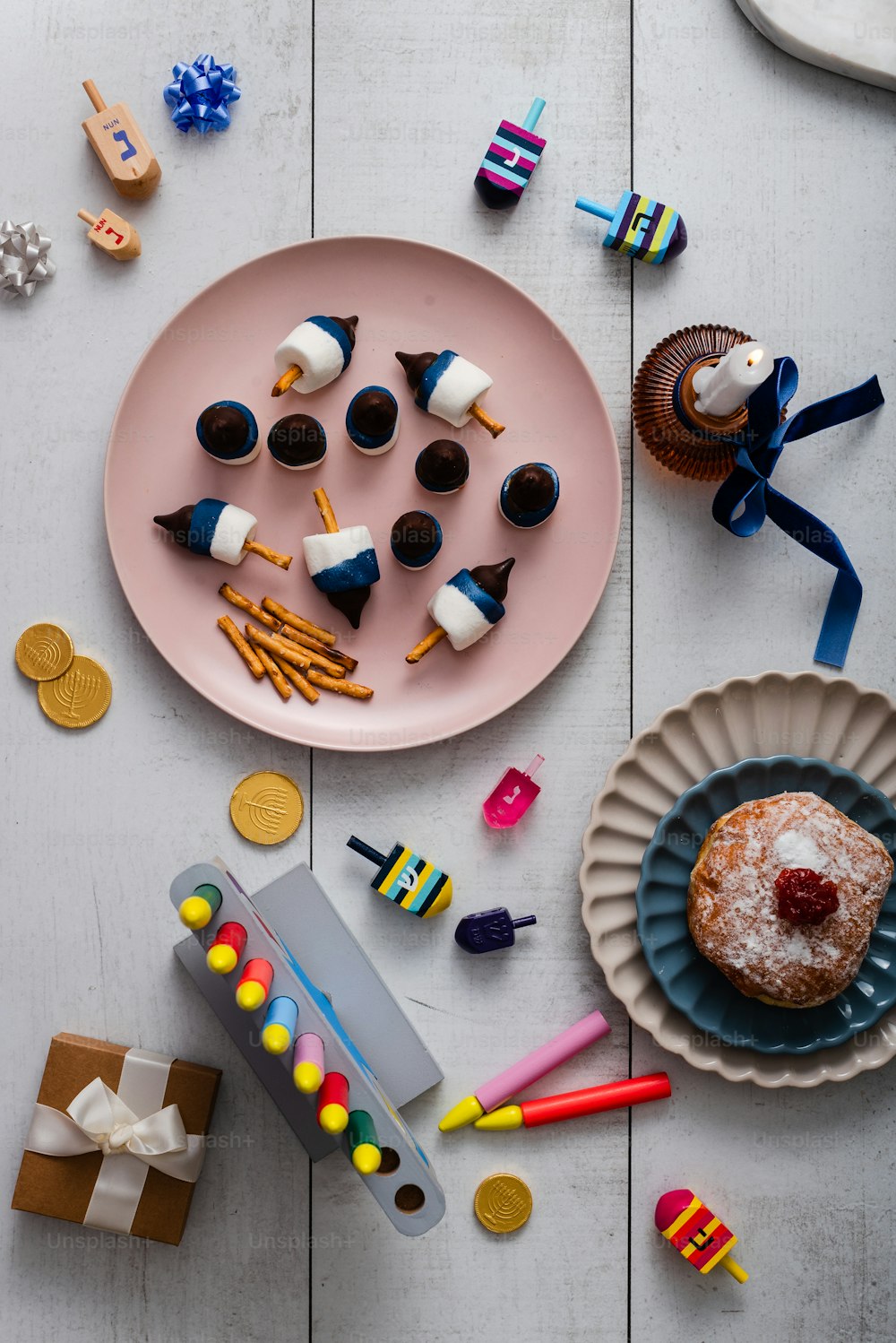 a pink plate topped with a donut covered in icing