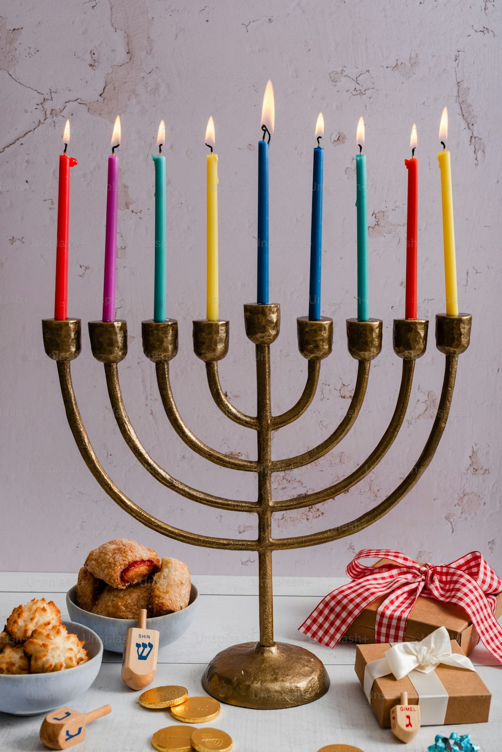 a hanukkah menorah with a bowl of cookies and a box