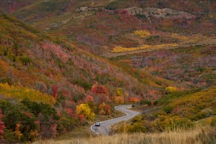 a car driving down a winding road in the mountains