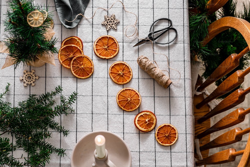 a table topped with orange slices and a candle