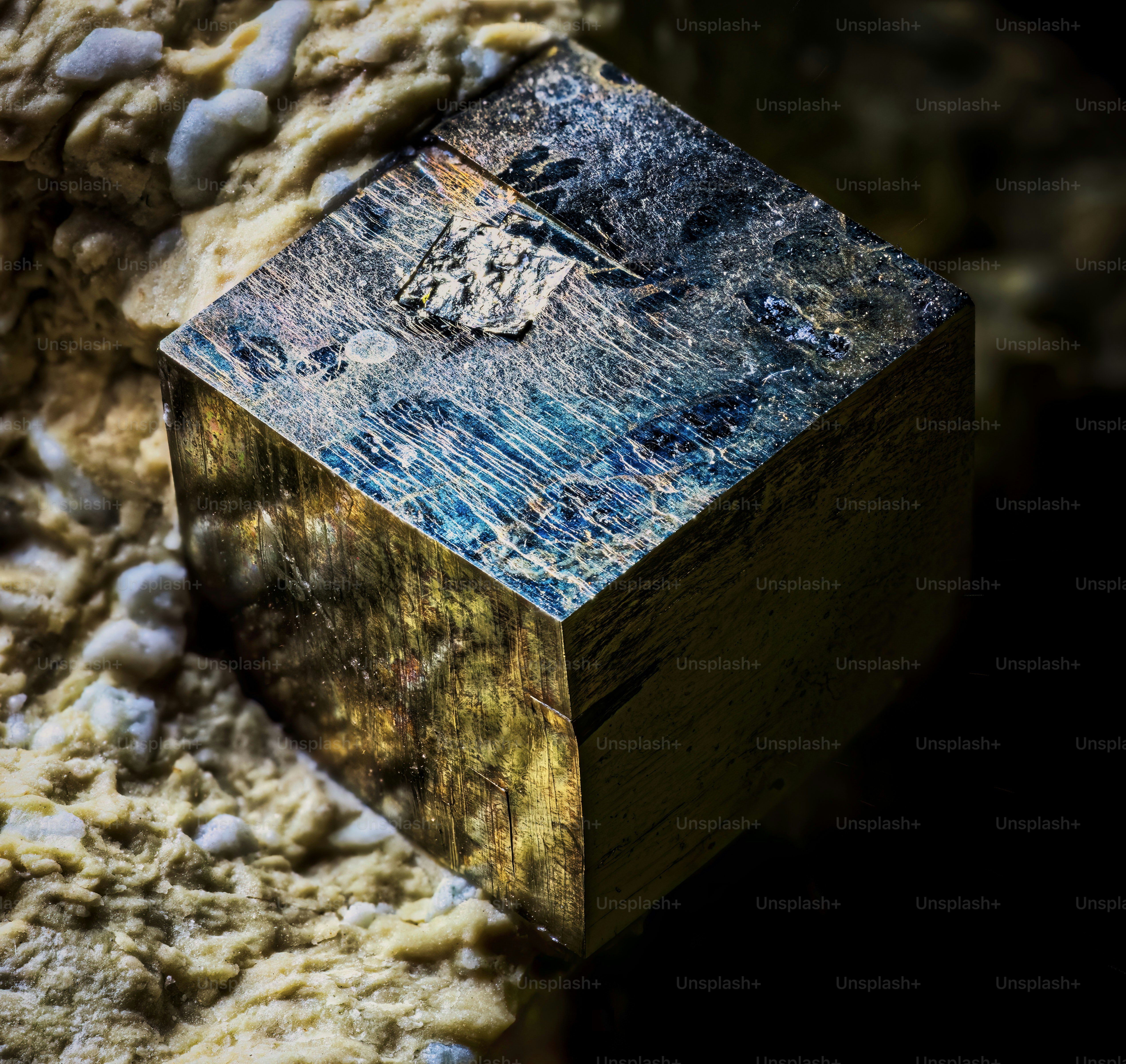 a piece of metal sitting on top of a pile of rocks