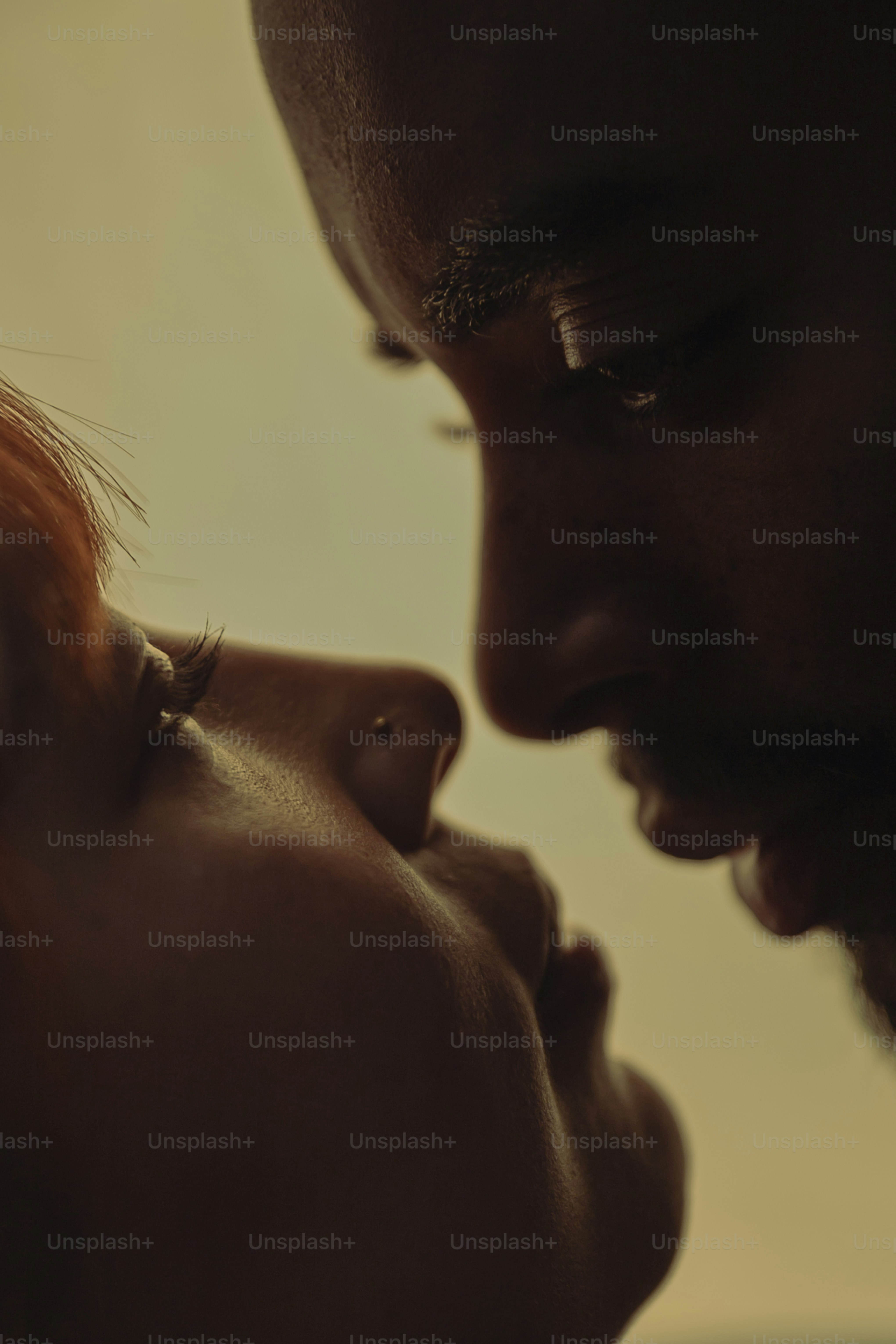 a close up of a man kissing a woman