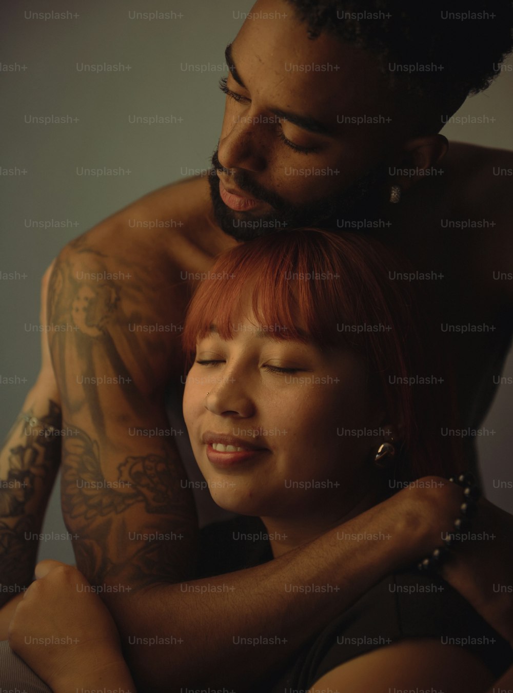 a man and a woman with tattoos on their arms