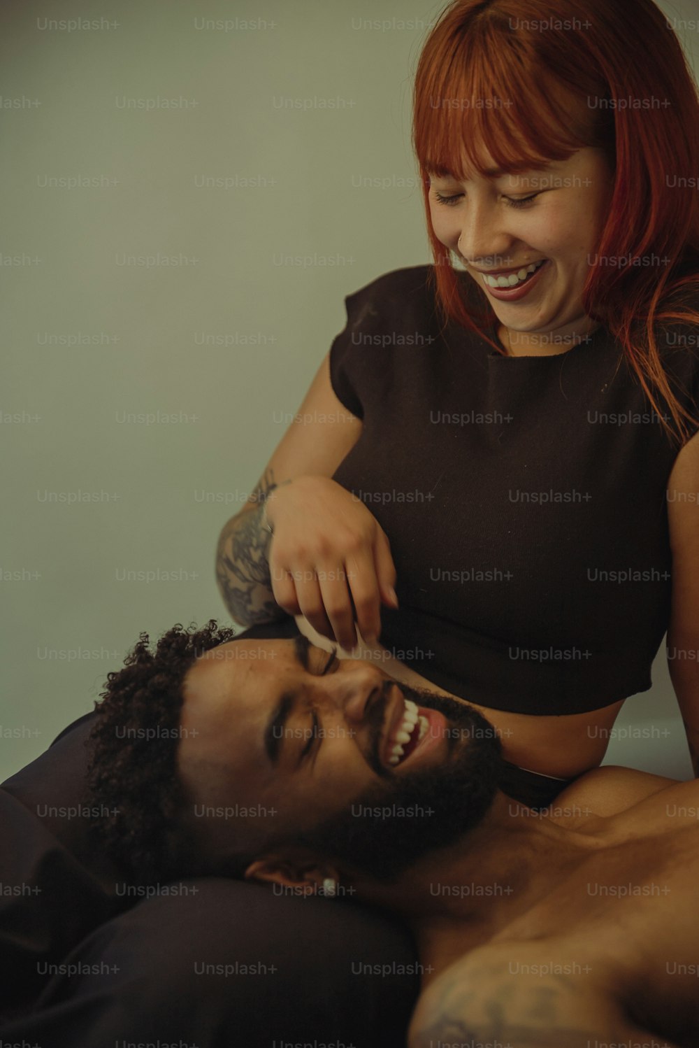 a woman cutting a man's hair with a pair of scissors