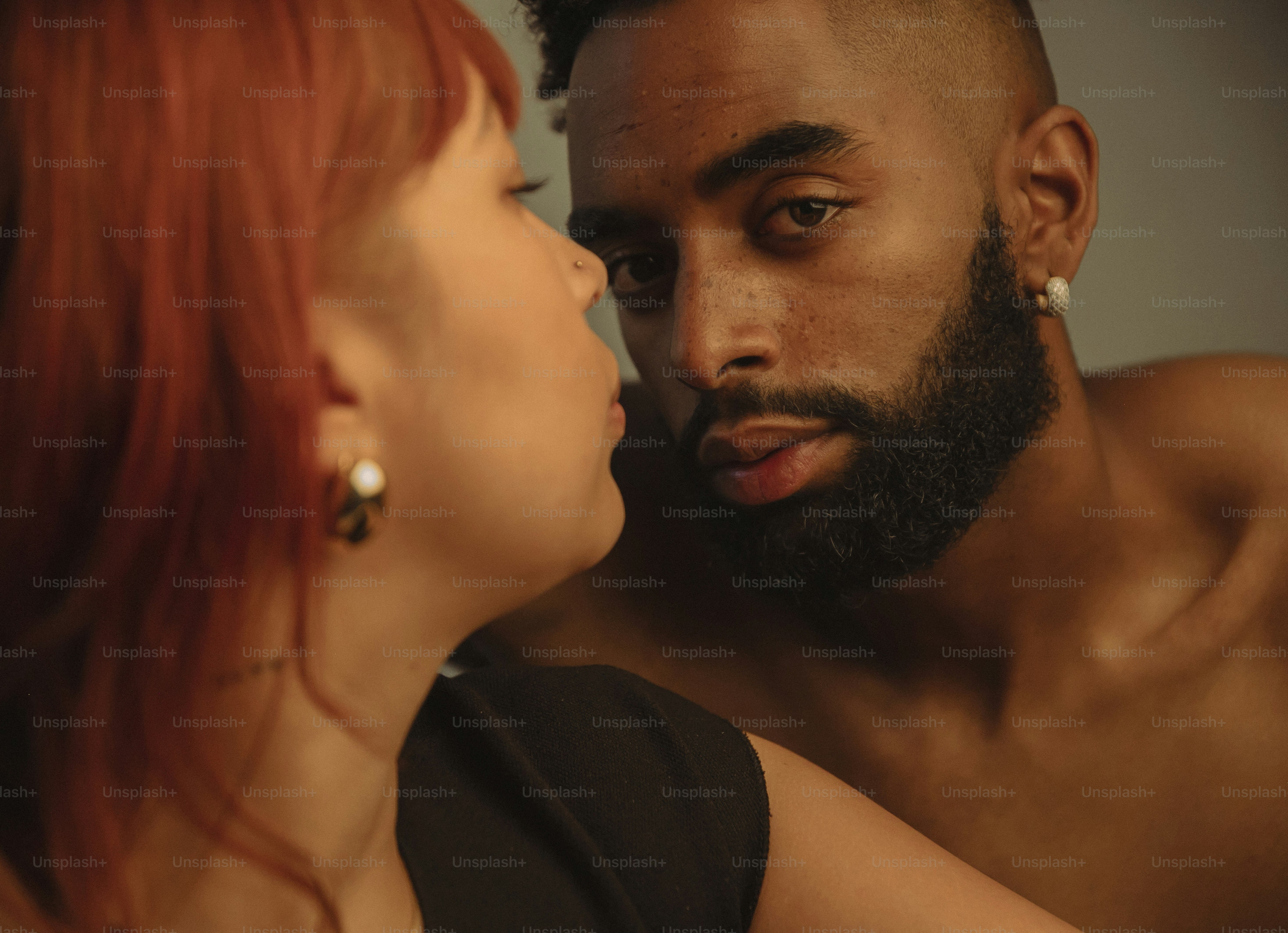 a man and a woman are looking at each other