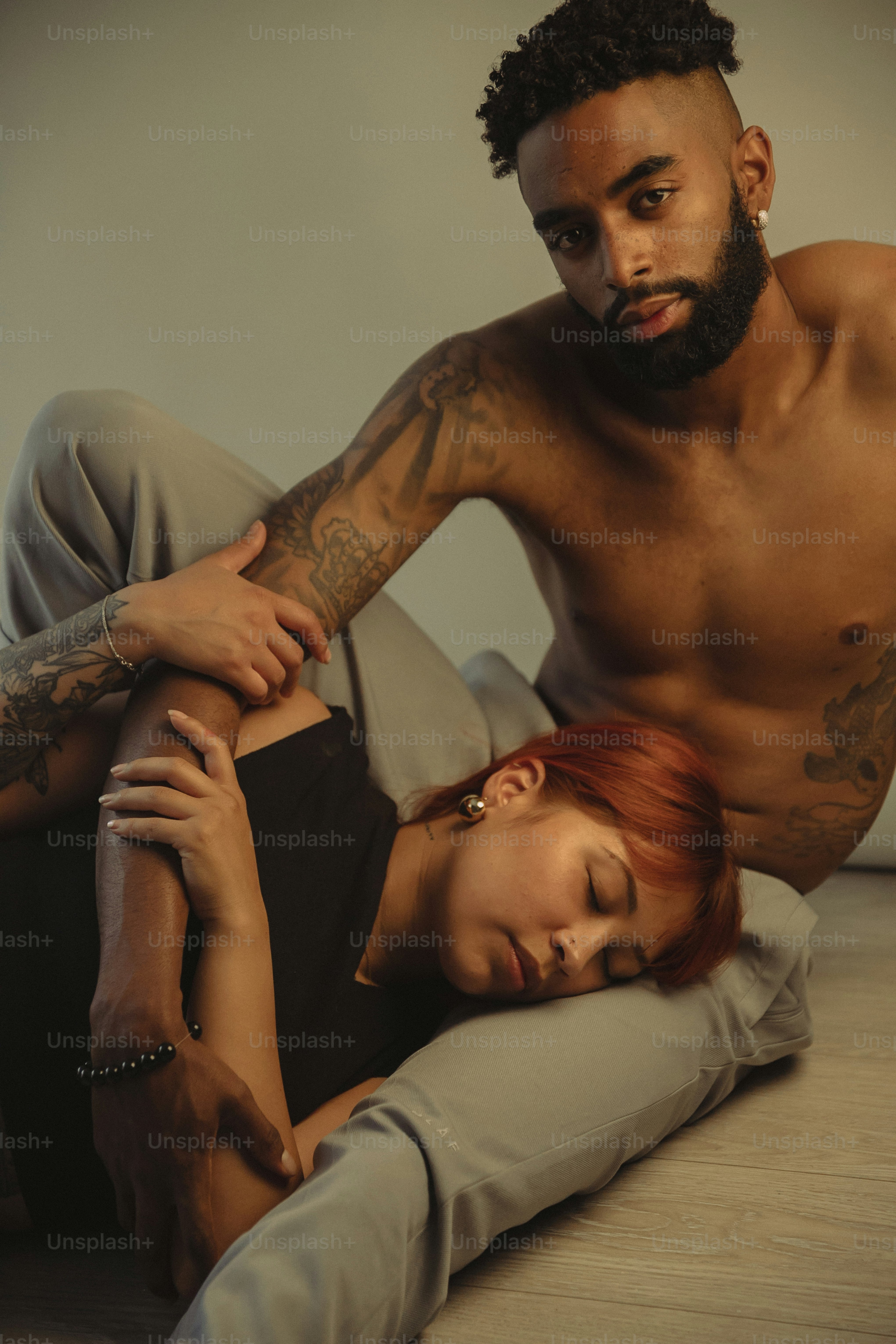 a man and a woman laying on the floor