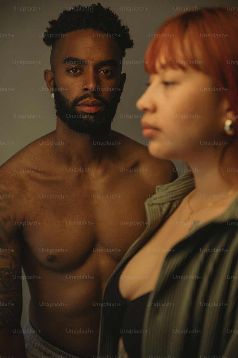 a man and a woman are looking at each other