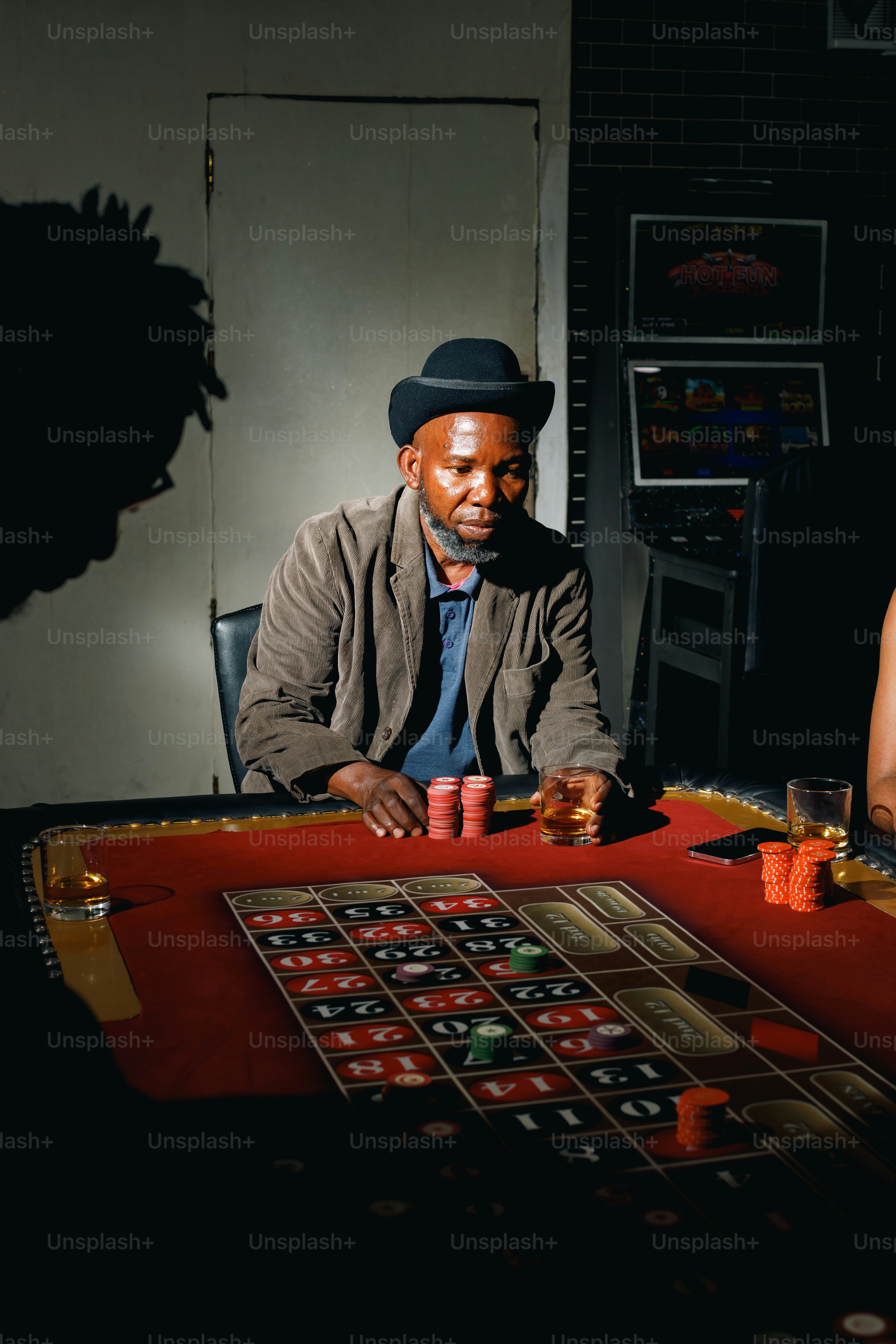 a man sitting at a casino table with a woman