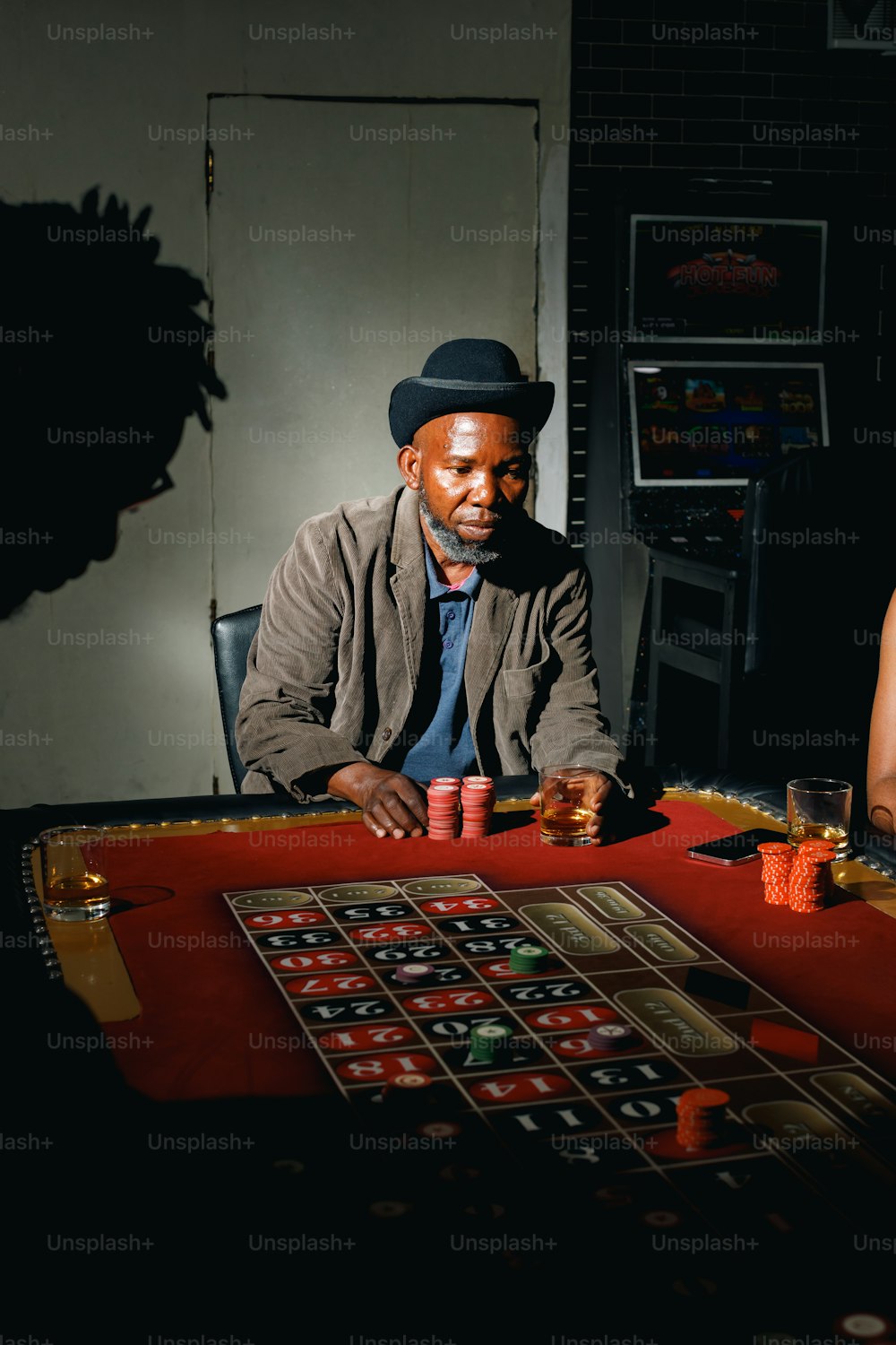 a man sitting at a casino table with a woman