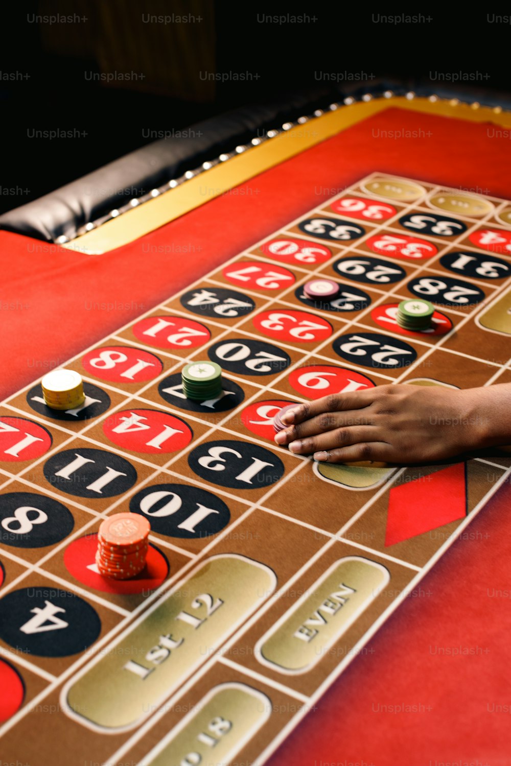 a person is playing roulejack on a red table