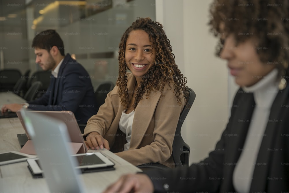 a woman sitting in front of a laptop computer