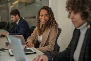 a woman sitting in front of a laptop computer